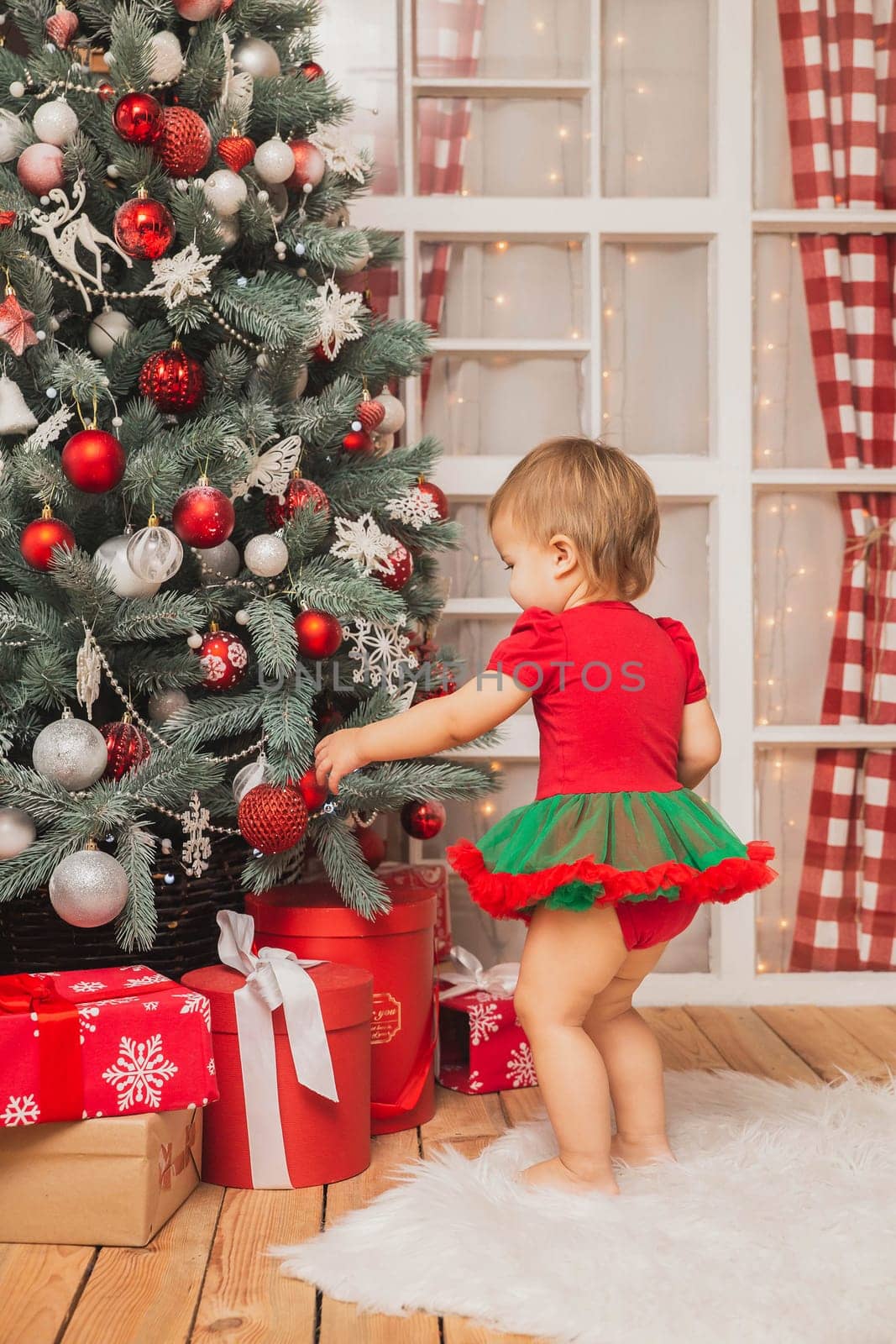 Beautiful baby in new Year costume standing near the christmas tree by Viktor_Osypenko