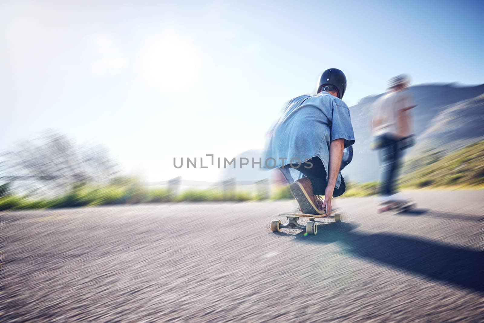 Speed, fast and men skateboarding in the street for adventure, training and exercise in Philippines. Fitness, sport and friends in motion, moving and travel in the road on a skateboard in summer.