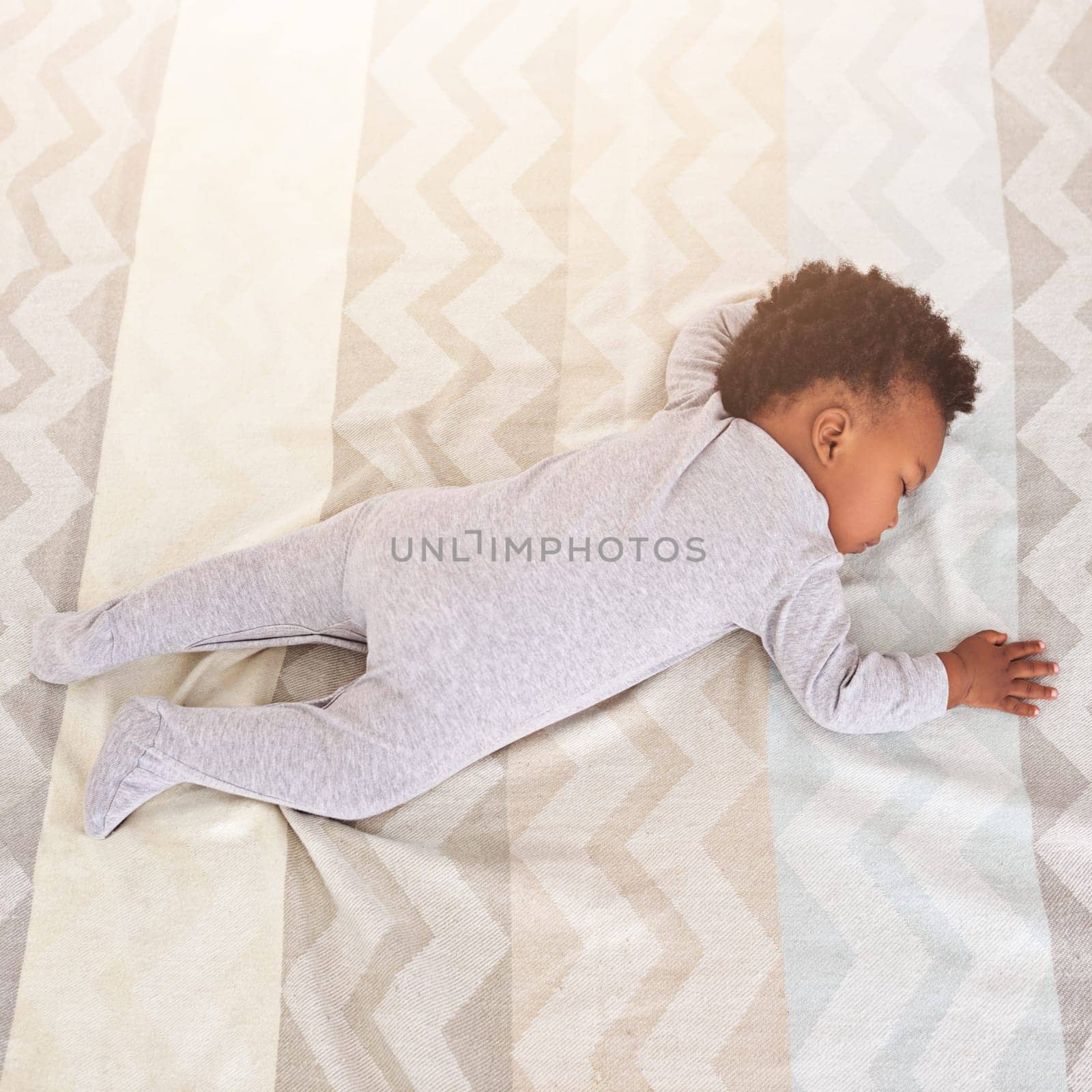 Top view, bed and baby sleeping in nursery with lens flare for rest, nap time and dreaming in home. Childcare, newborn and cute, tired and African child in bedroom sleep for comfort, relax and calm.
