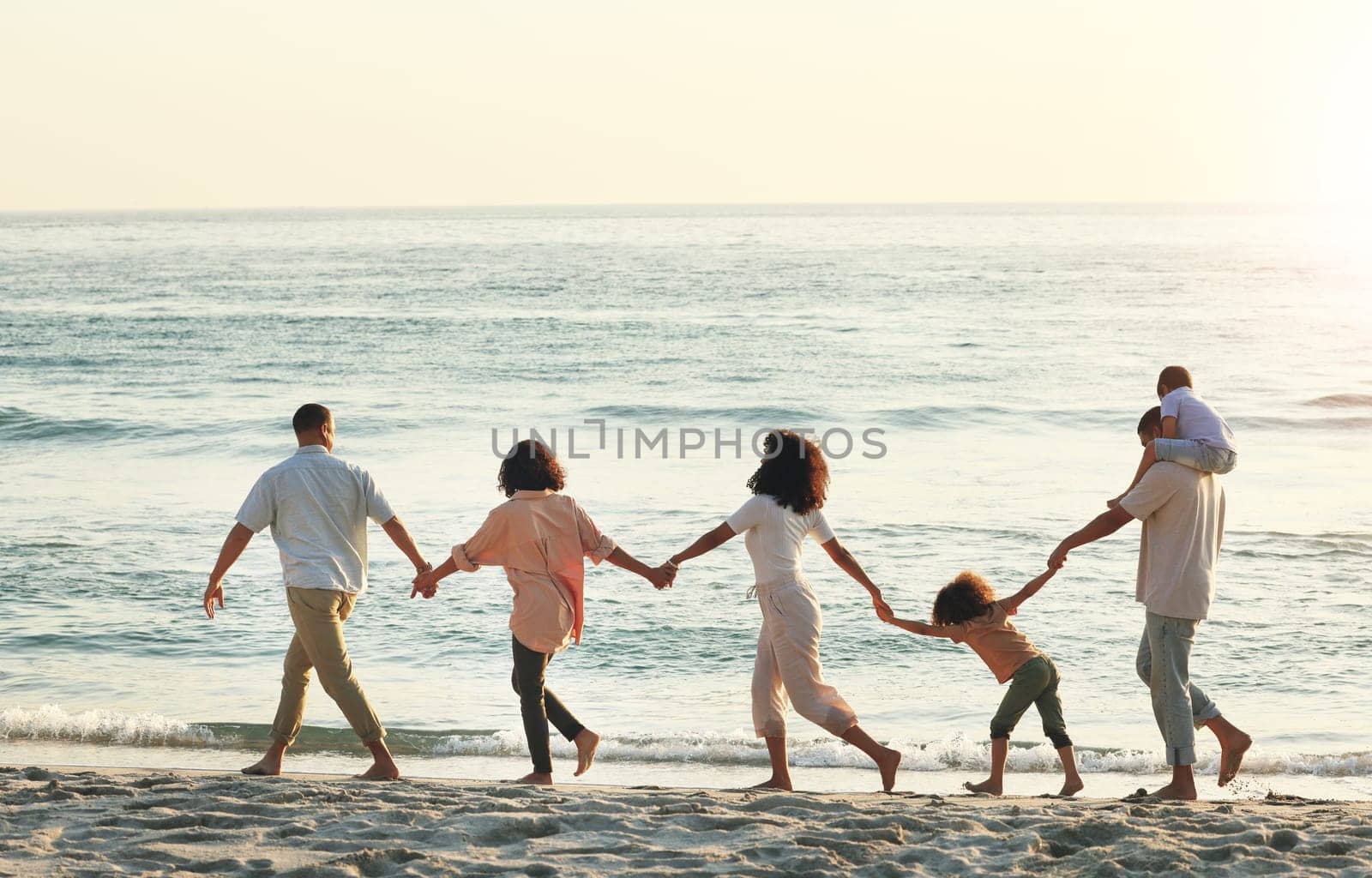 Big family, walking and holding hands at beach at sunset, having fun and bonding on vacation outdoors. Care, mockup and kids, grandmother and grandfather with mother and father enjoying holiday time.