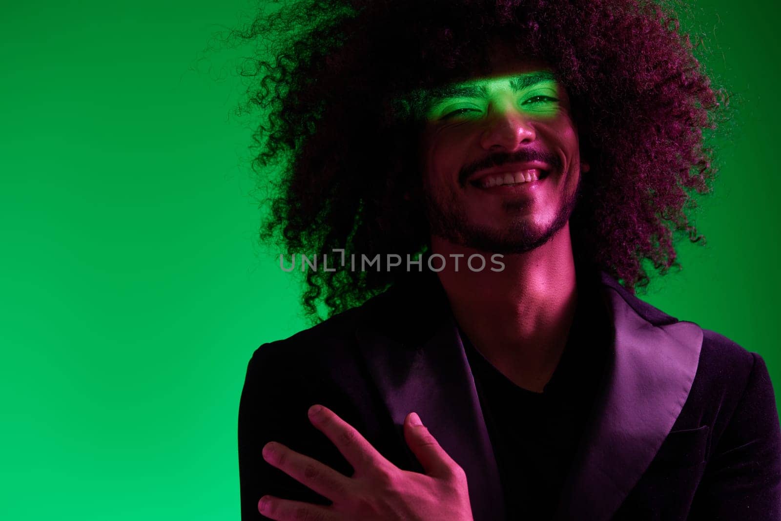 Portrait of a stylish man in a jacket on a green background multinational, color light, trend by SHOTPRIME