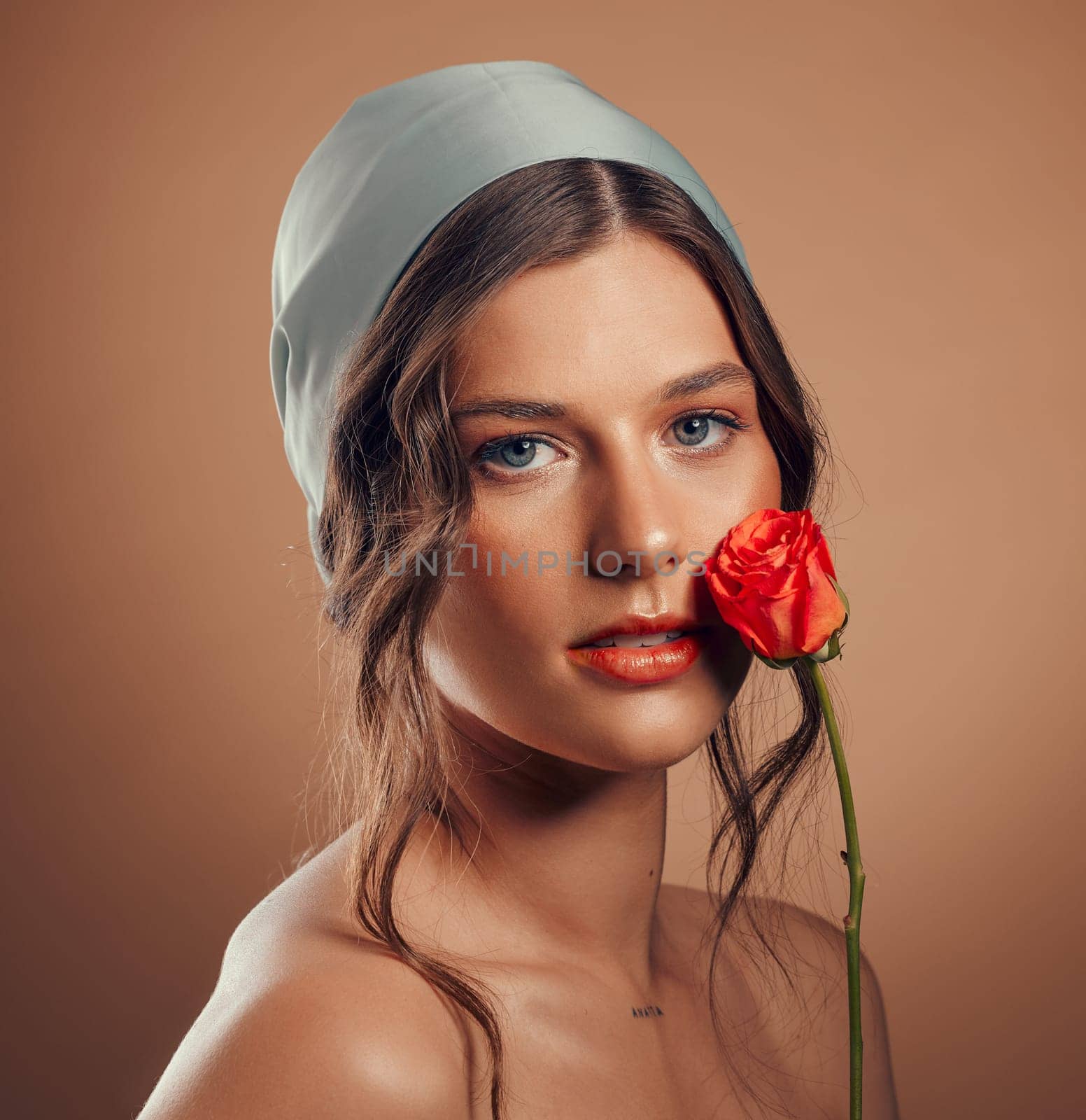 Rose, woman and face with natural beauty, skincare and luxury cosmetics of floral aesthetic, perfume or facial makeup on studio background. Headshot, portrait and model with roses, nature and flowers.