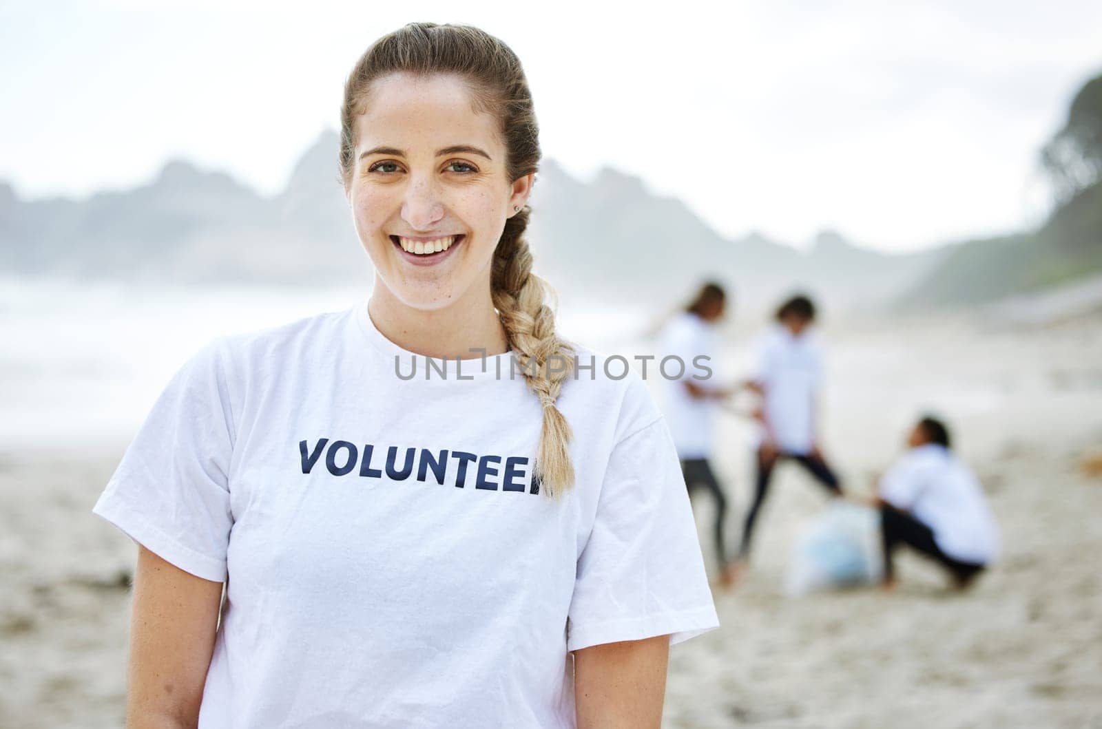 Smile, volunteer portrait and woman at beach for cleaning, recycling or environmental sustainability. Earth day, happy face and proud female for community service, charity and climate change at ocean.