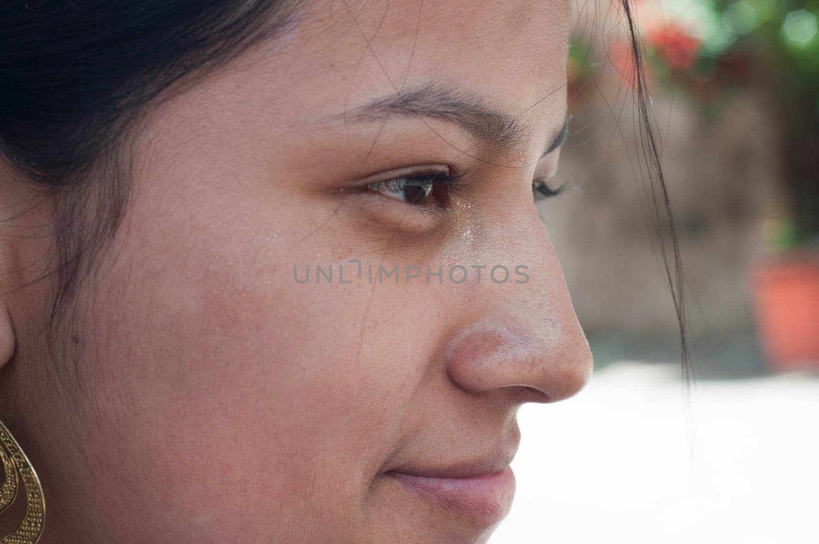 attractive indigenous woman in profile thinking and meditating in a park. High quality photo