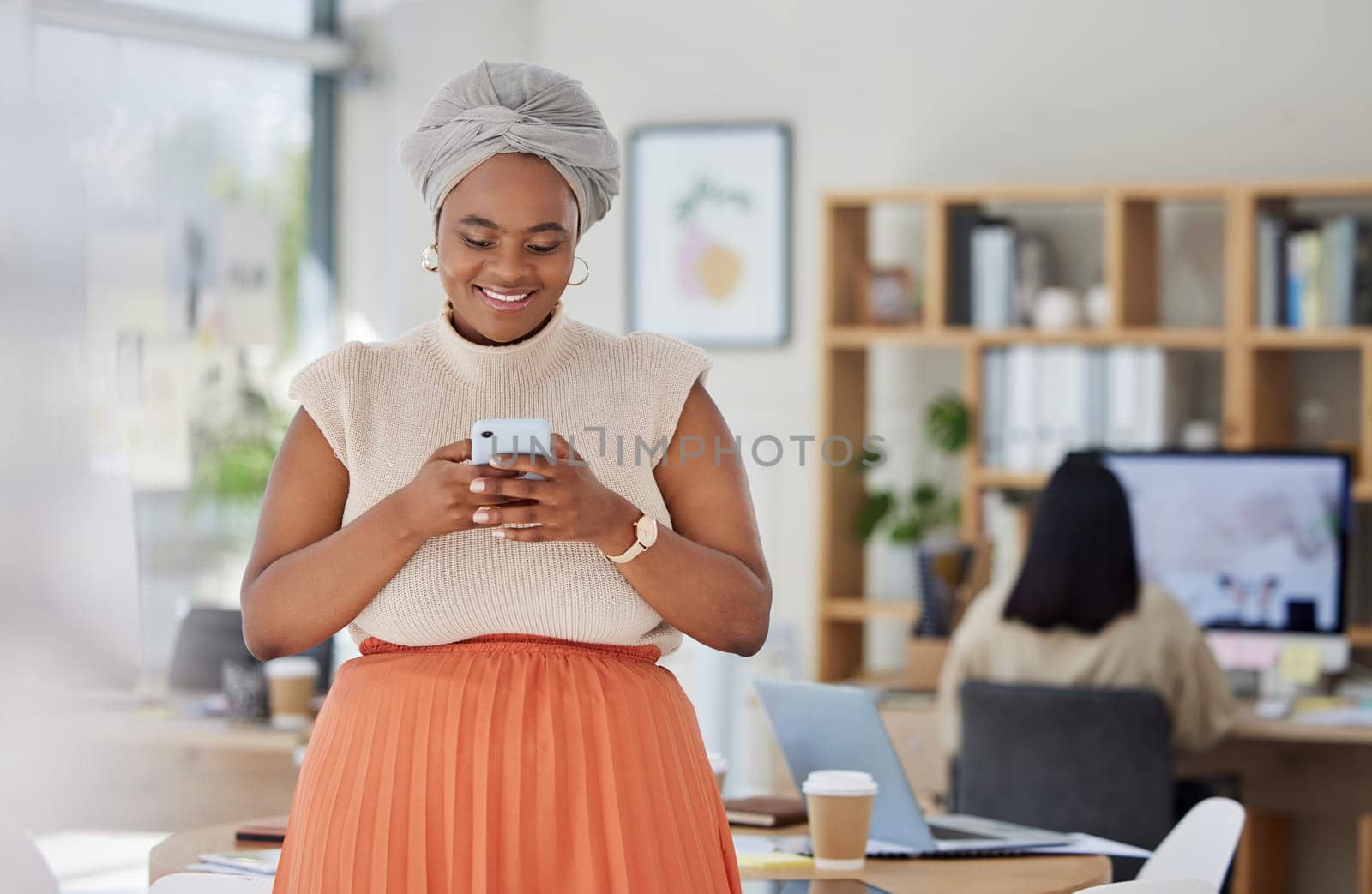 Business woman typing on social media on phone at work, reading email and networking with people online on a smartphone in an office. Happy black woman in communication on internet with technology by YuriArcurs