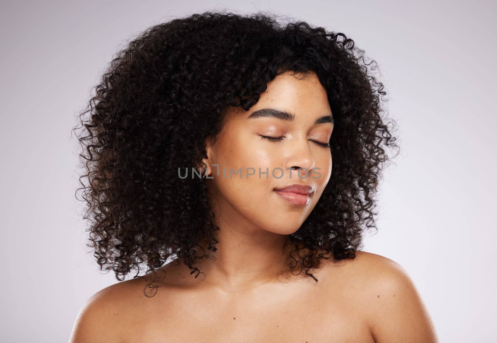Beauty, black woman and skincare with cosmetics, dermatology and foundation against grey studio background. African American female, lady and makeup with healthy, smooth and clear skin with grooming.