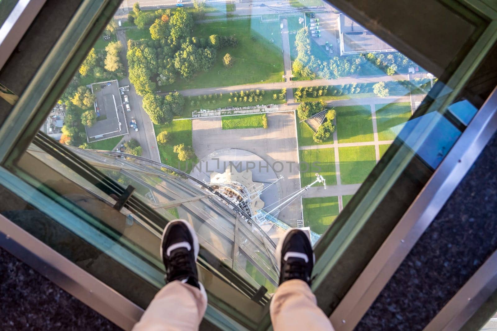 Female feet on glass floor at the Ostankino tower in Moscow, Russia by Mariakray
