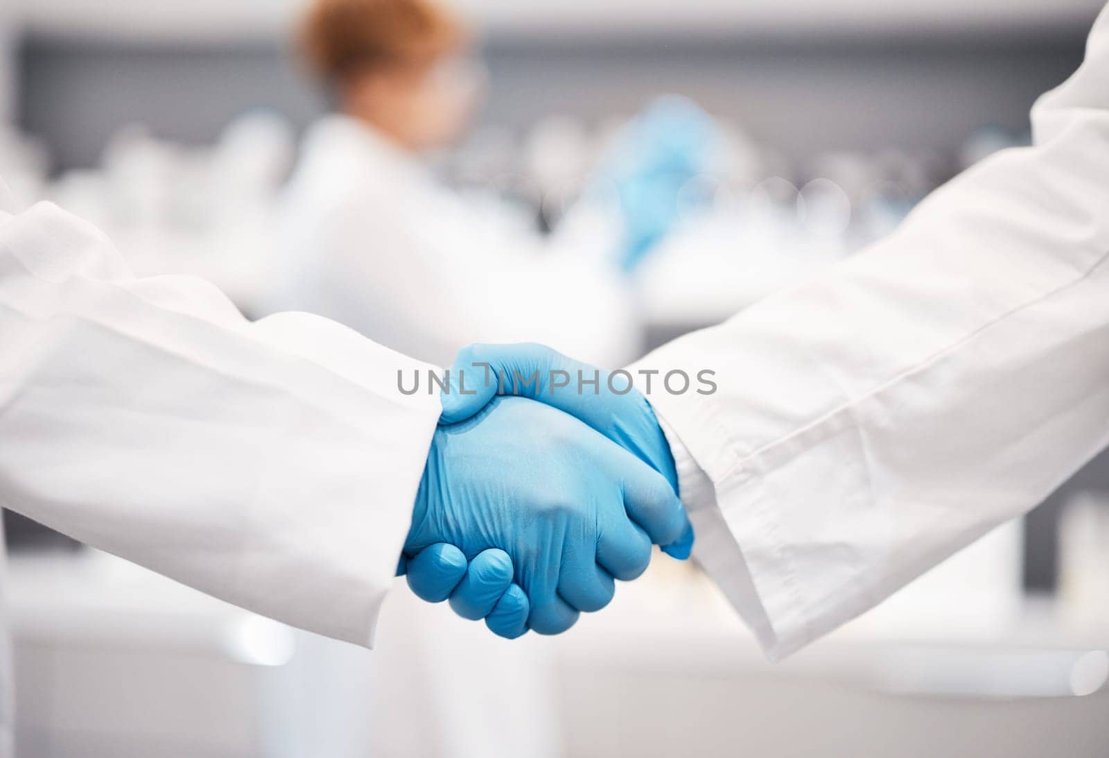 Doctor, shaking hands and gloves for safety in healthcare, partnership or trust for collaboration, unity or support at lab. Team of medical experts handshake in teamwork for agreement or success.