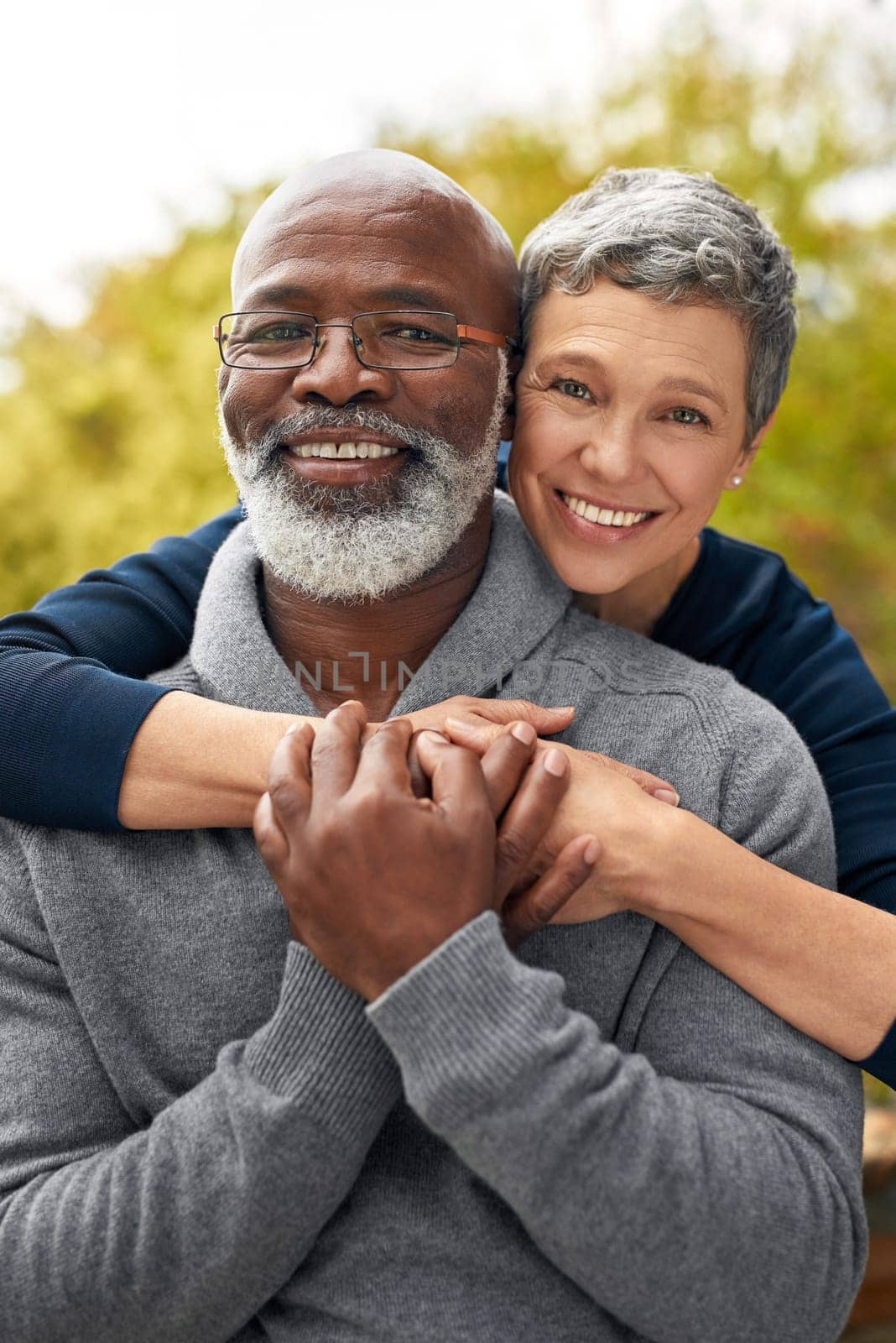 Portrait, park or senior couple with hug, interracial or romantic with bonding, marriage or relationship. Face, mature black man or elderly woman embrace, retirement or partners with romance or love.