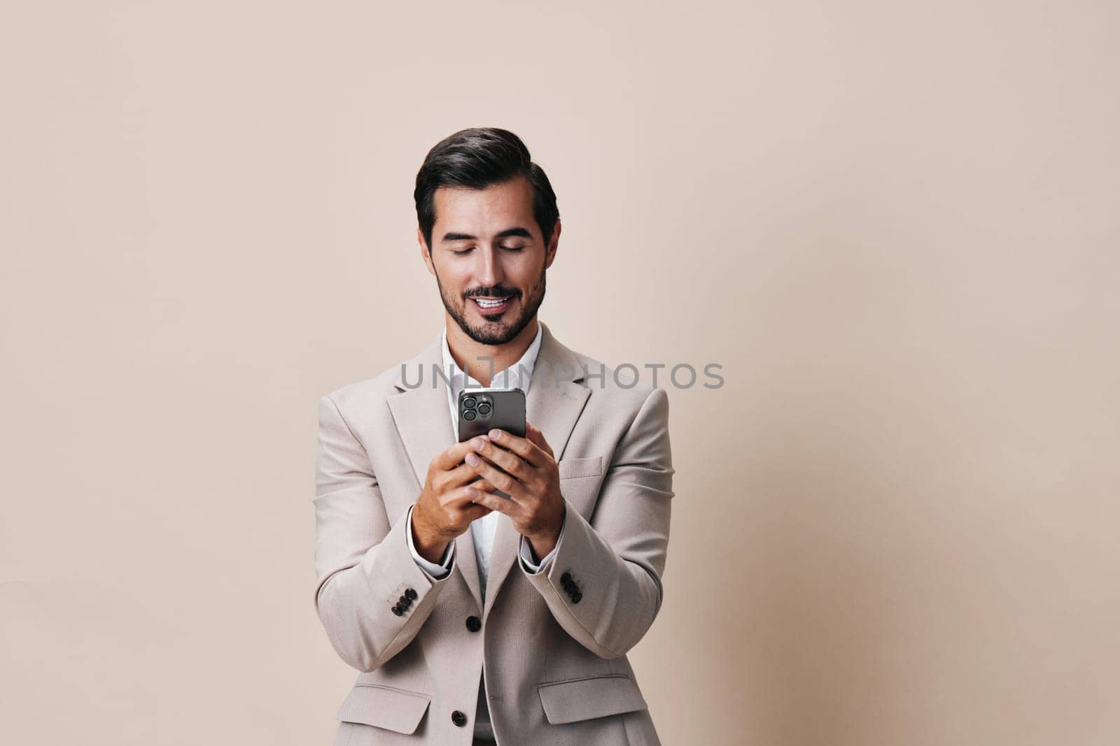 man smartphone suit handsome business application young phone success happy portrait person beard call smile confident internet studio corporate hold lifestyle