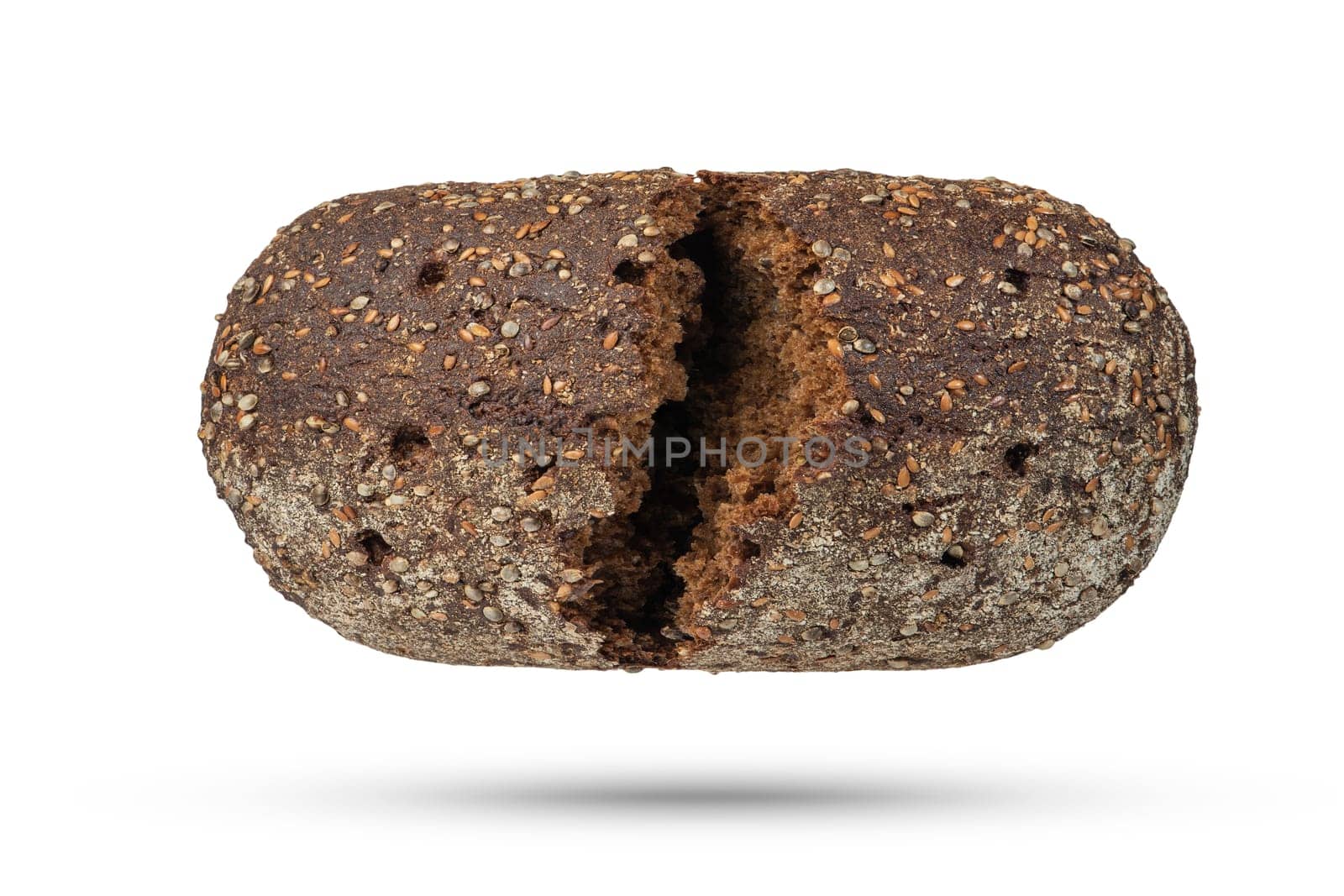 A loaf of black bread on a white isolated background. The loaf is broken into 2 parts on a white background. by SERSOL