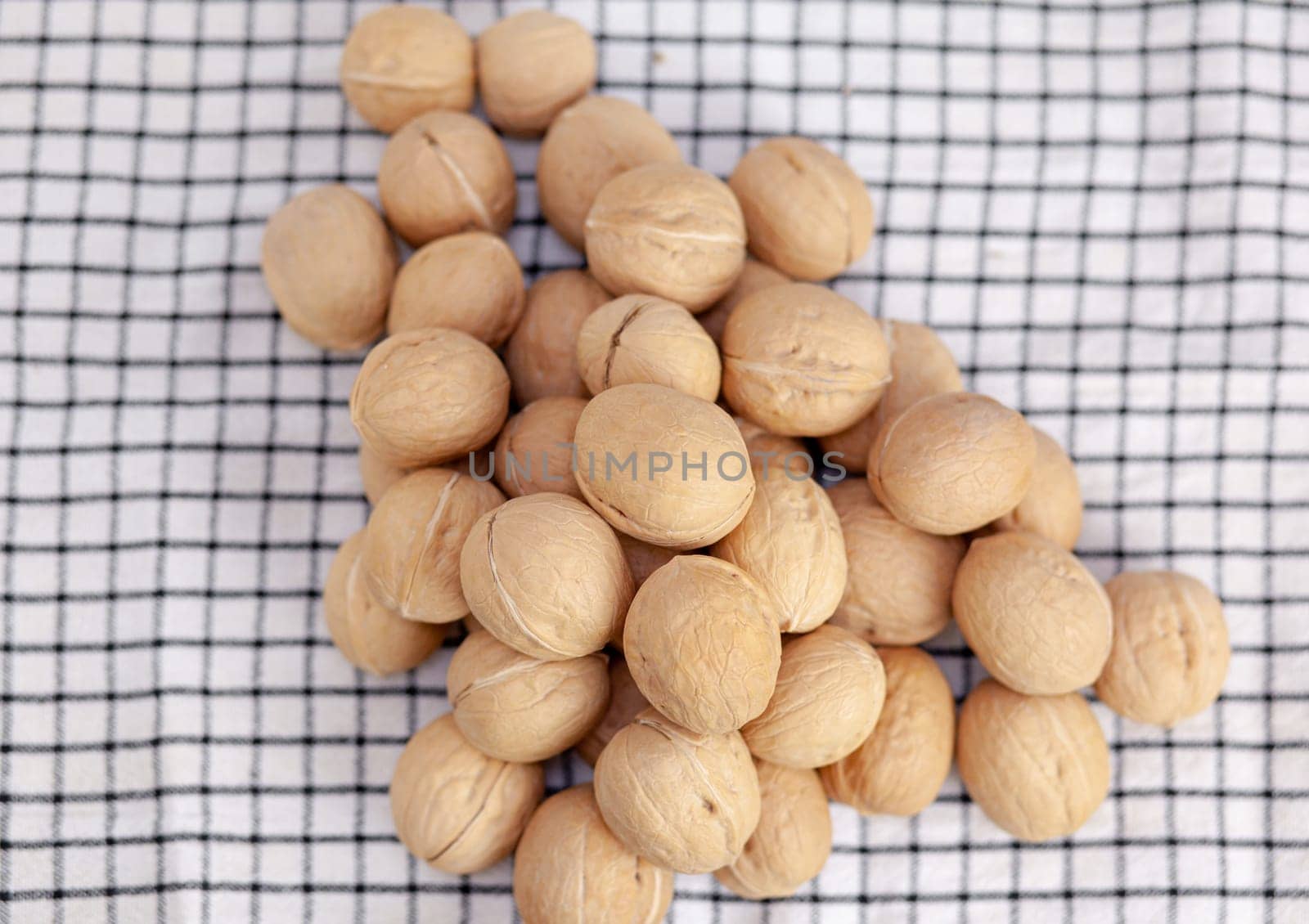 A lot of whole walnuts on a napkin. Healthy, organic and healthy food by AnatoliiFoto