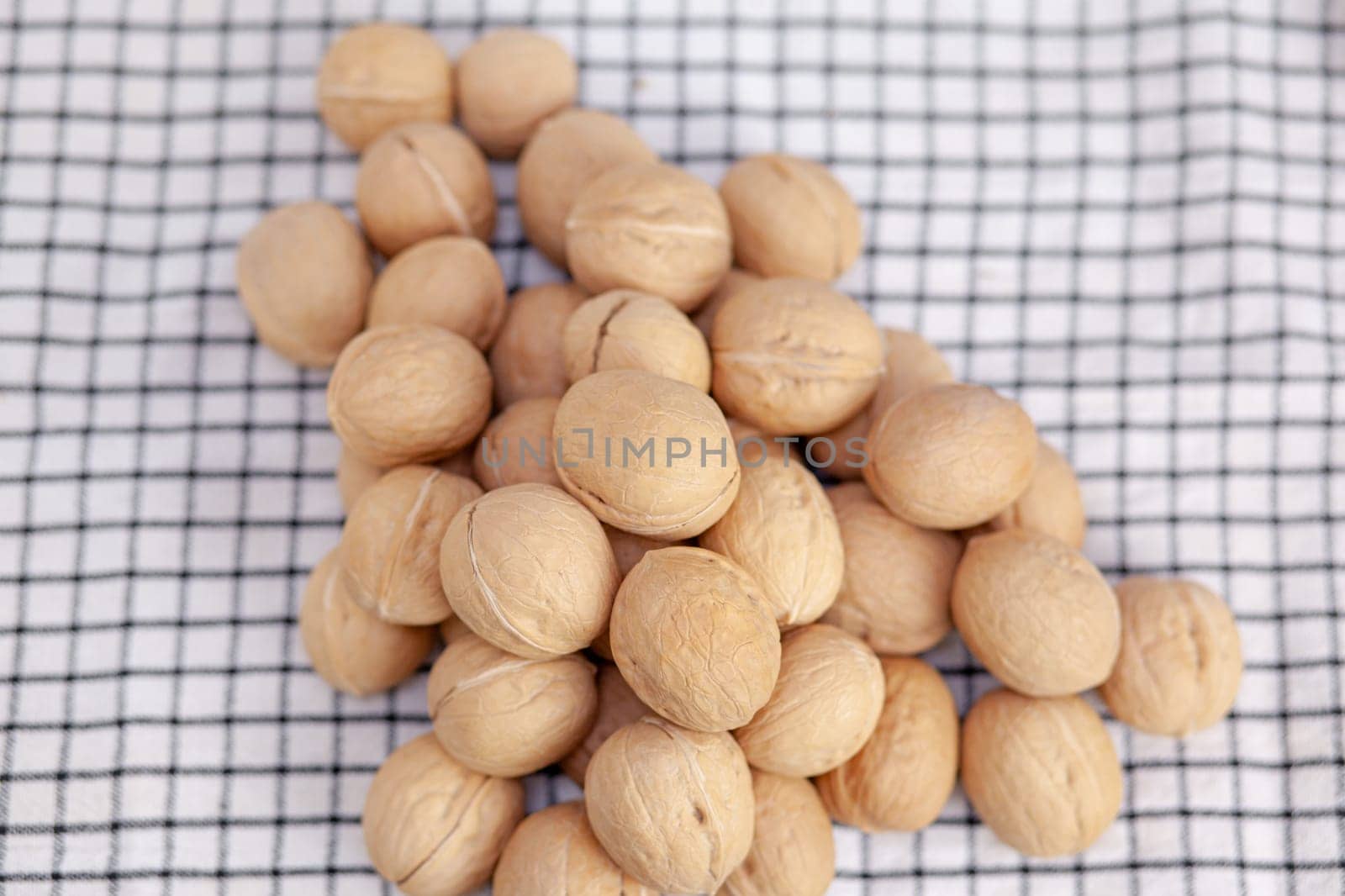 A lot of whole walnuts on a napkin. Healthy, organic and healthy food by AnatoliiFoto