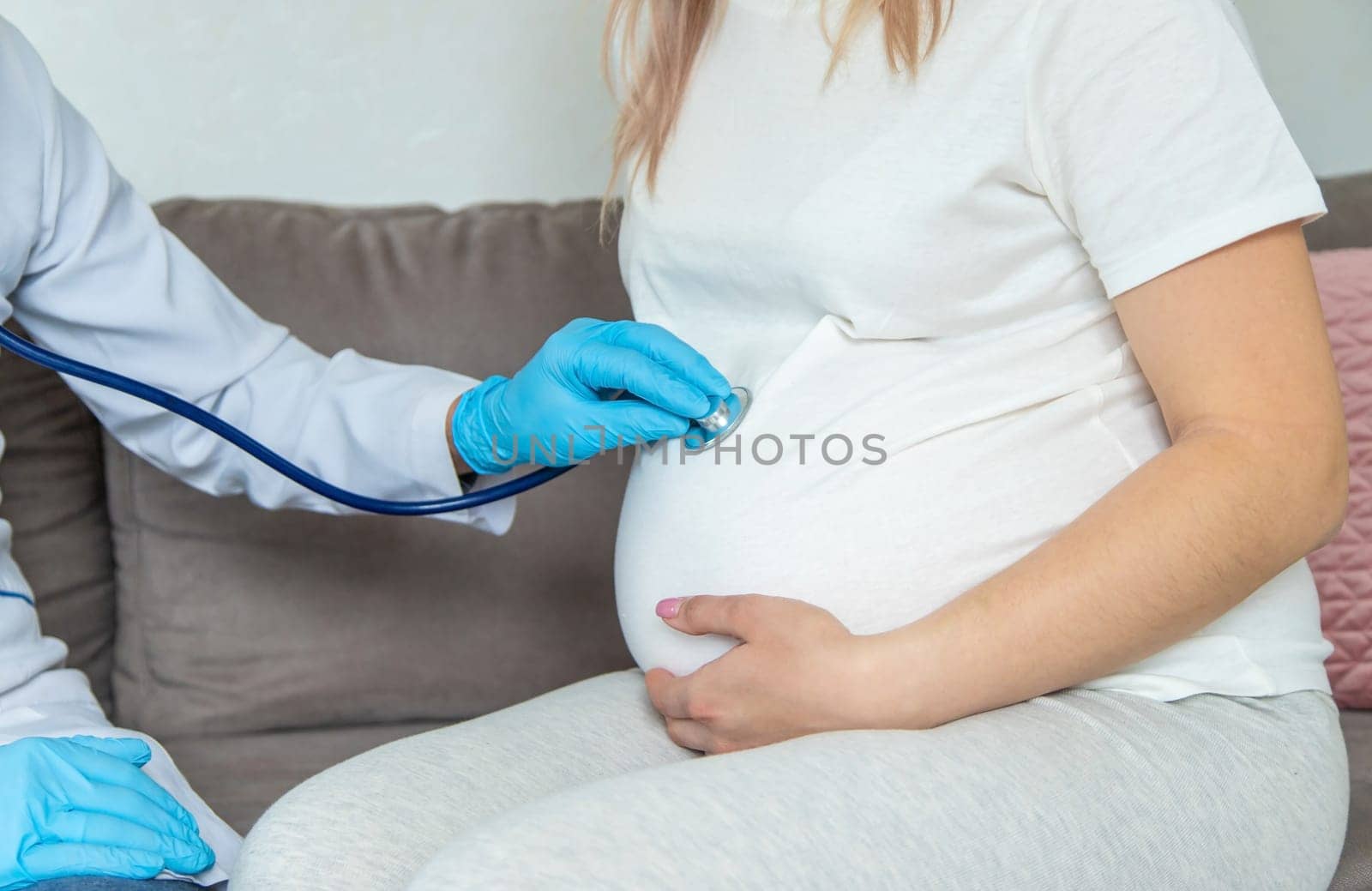 The doctor examines the belly of a pregnant woman. Selective focus. medicine.