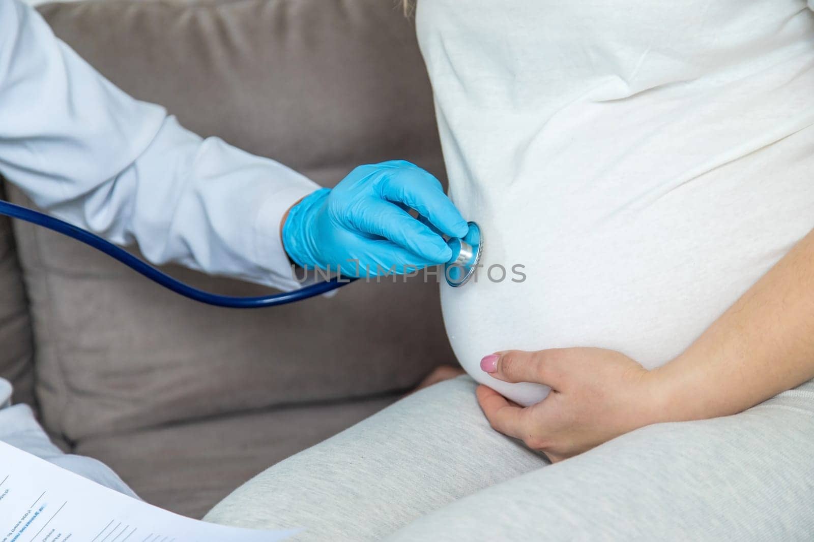 The doctor examines the belly of a pregnant woman. Selective focus. medicine.