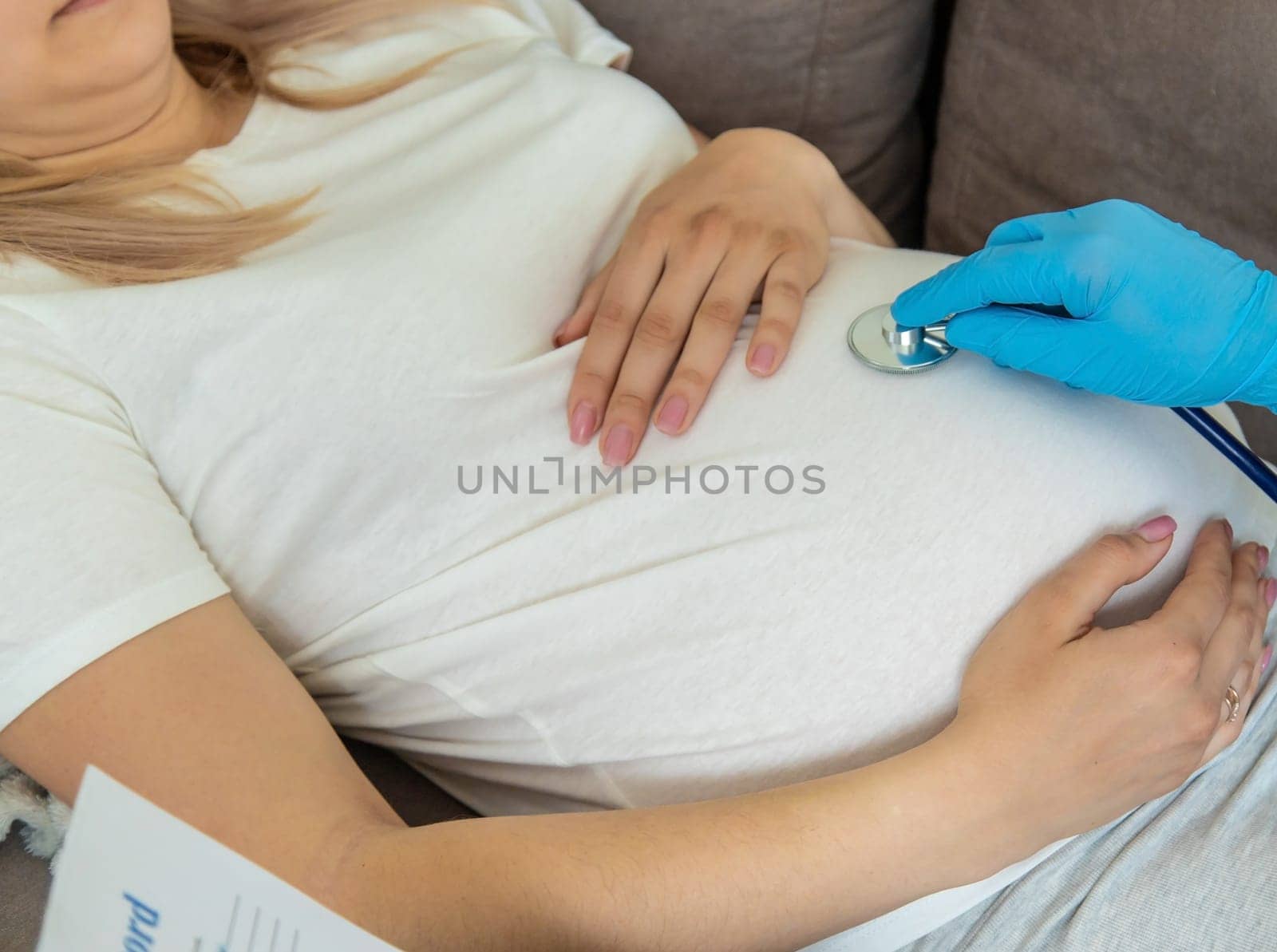 The doctor examines the belly of a pregnant woman. Selective focus. medicine.