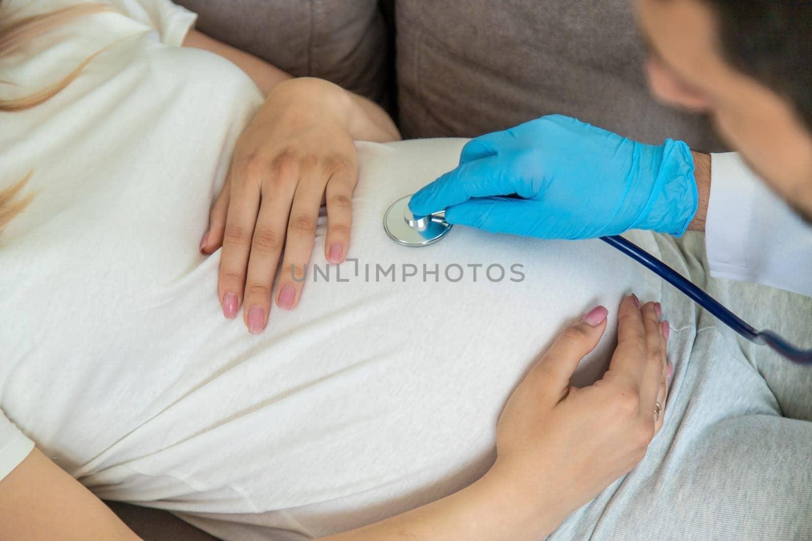 The doctor examines the belly of a pregnant woman. Selective focus. medicine.