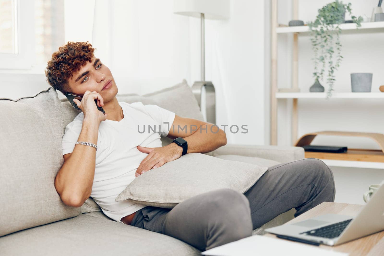 man interior adult home blogger mockup teenager sofa lifestyle business phone male student internet smart communication freelancer