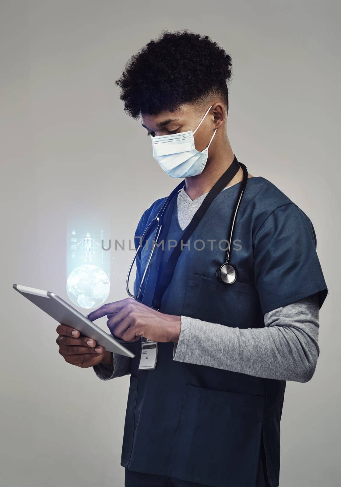 Man, doctor and digital tablet for global communication or healthcare research with covid mask. Male medical expert on technology for data, networking or hologram against a grey studio background.