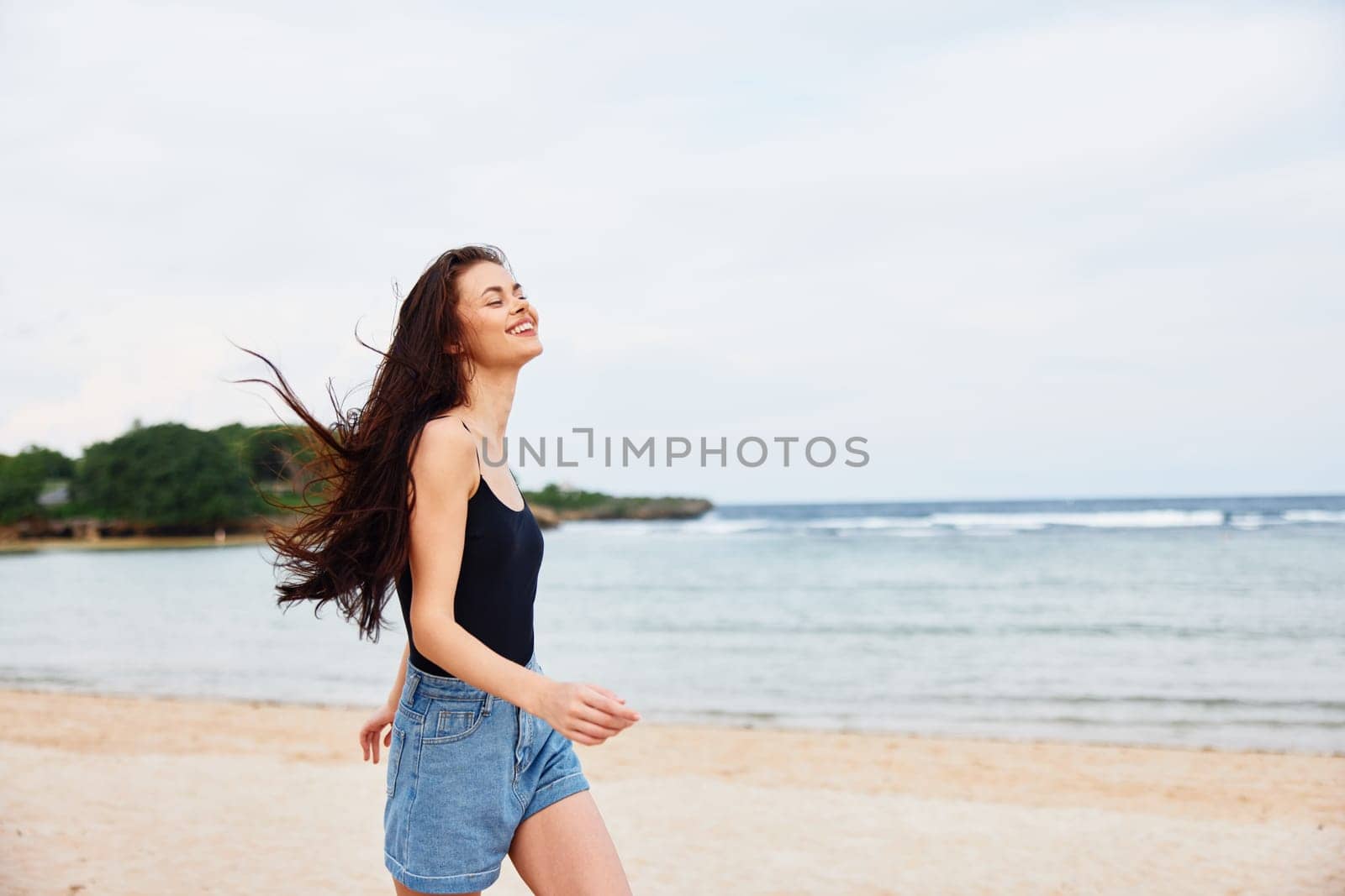 woman sea positive lifestyle summer smile young beach sunset running travel by SHOTPRIME
