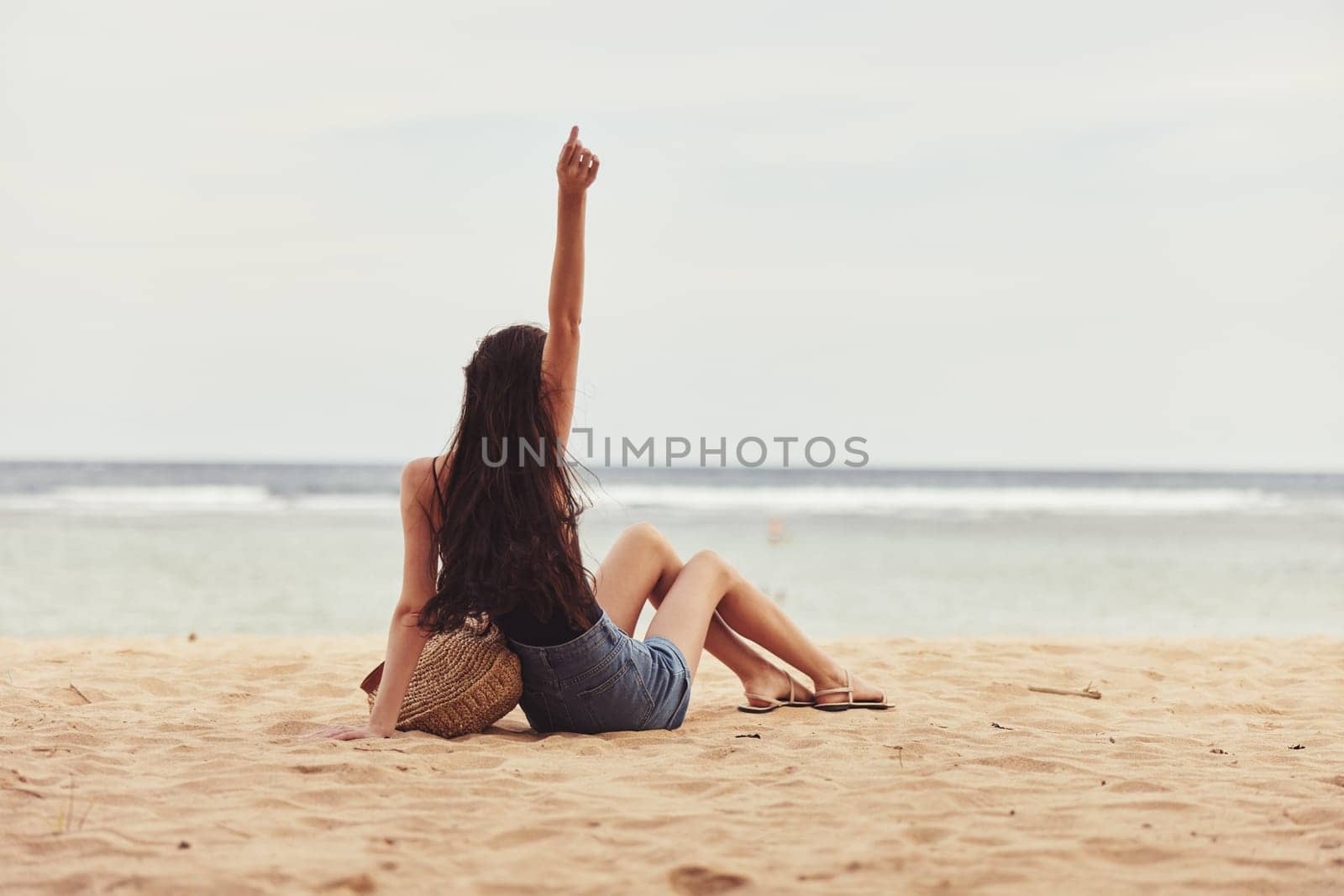 woman fashion relax hair beach holiday coast travel nature freedom sand sitting sea attractive vacation smile caucasian long girl sexy natural carefree