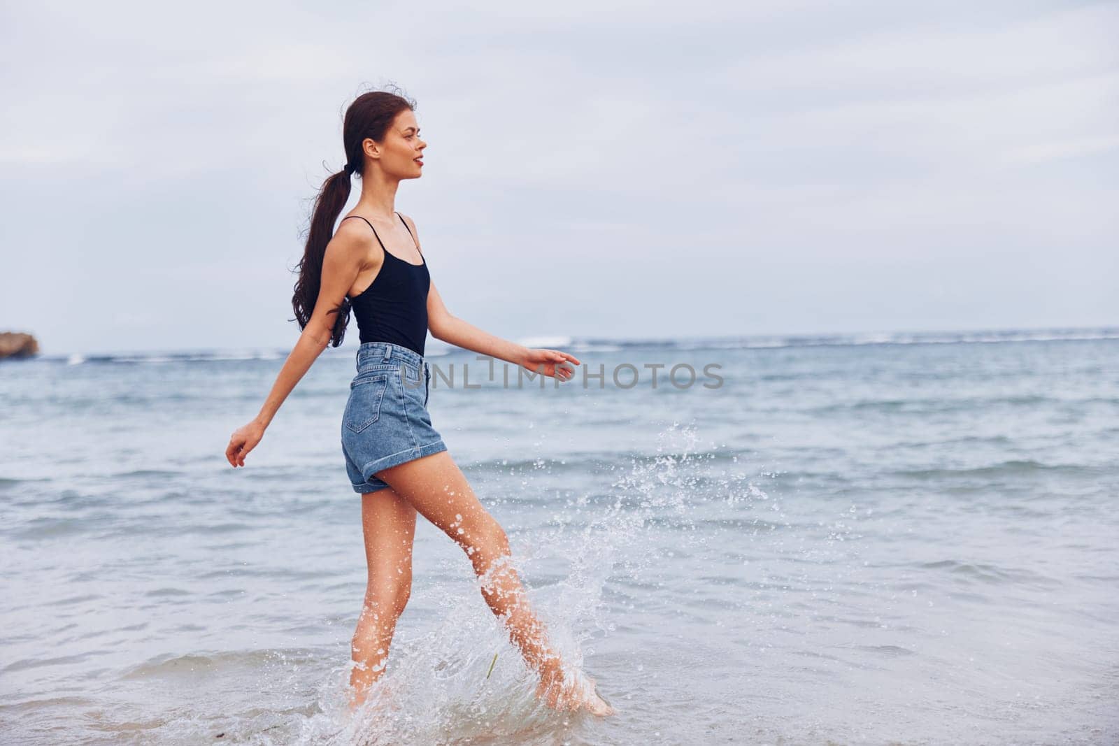 young woman vacation girl lifestyle sunset active beach smile person long travel hair beauty running shore hair nature sea freedom summer carefree