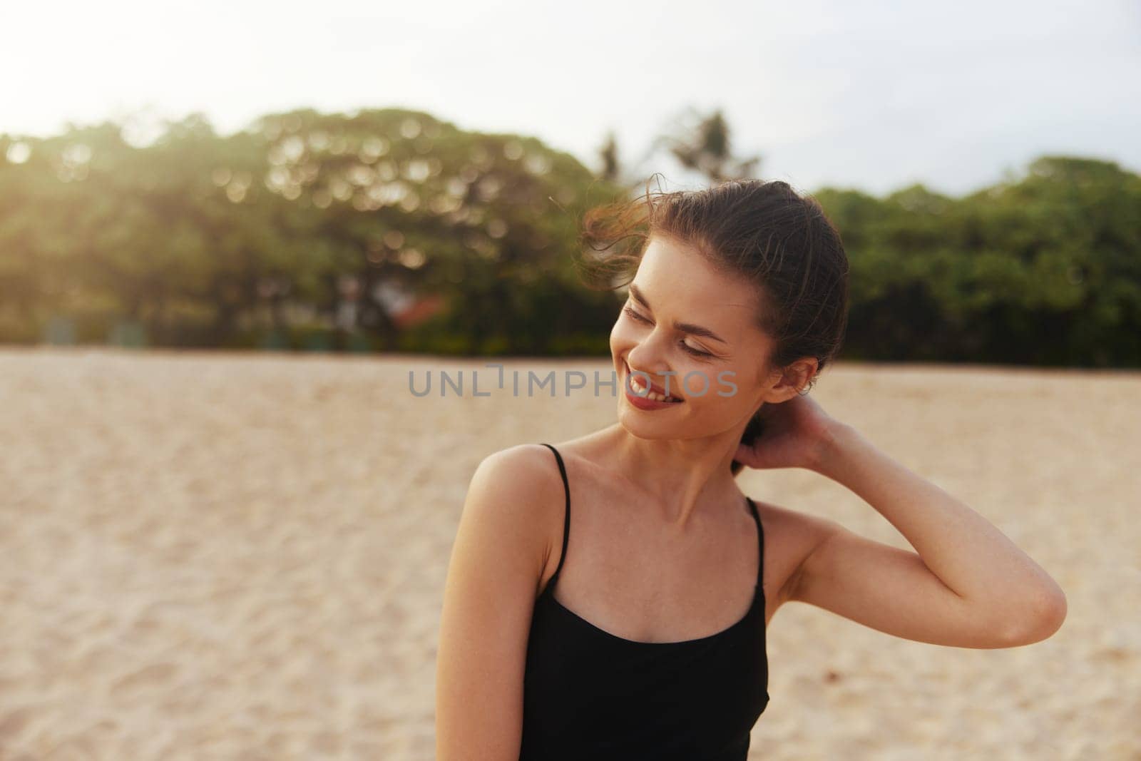 beach woman sunset sea travel lifestyle ocean smile person relax leisure hair happiness female young long walking sand summer vacation caucasian copy-space