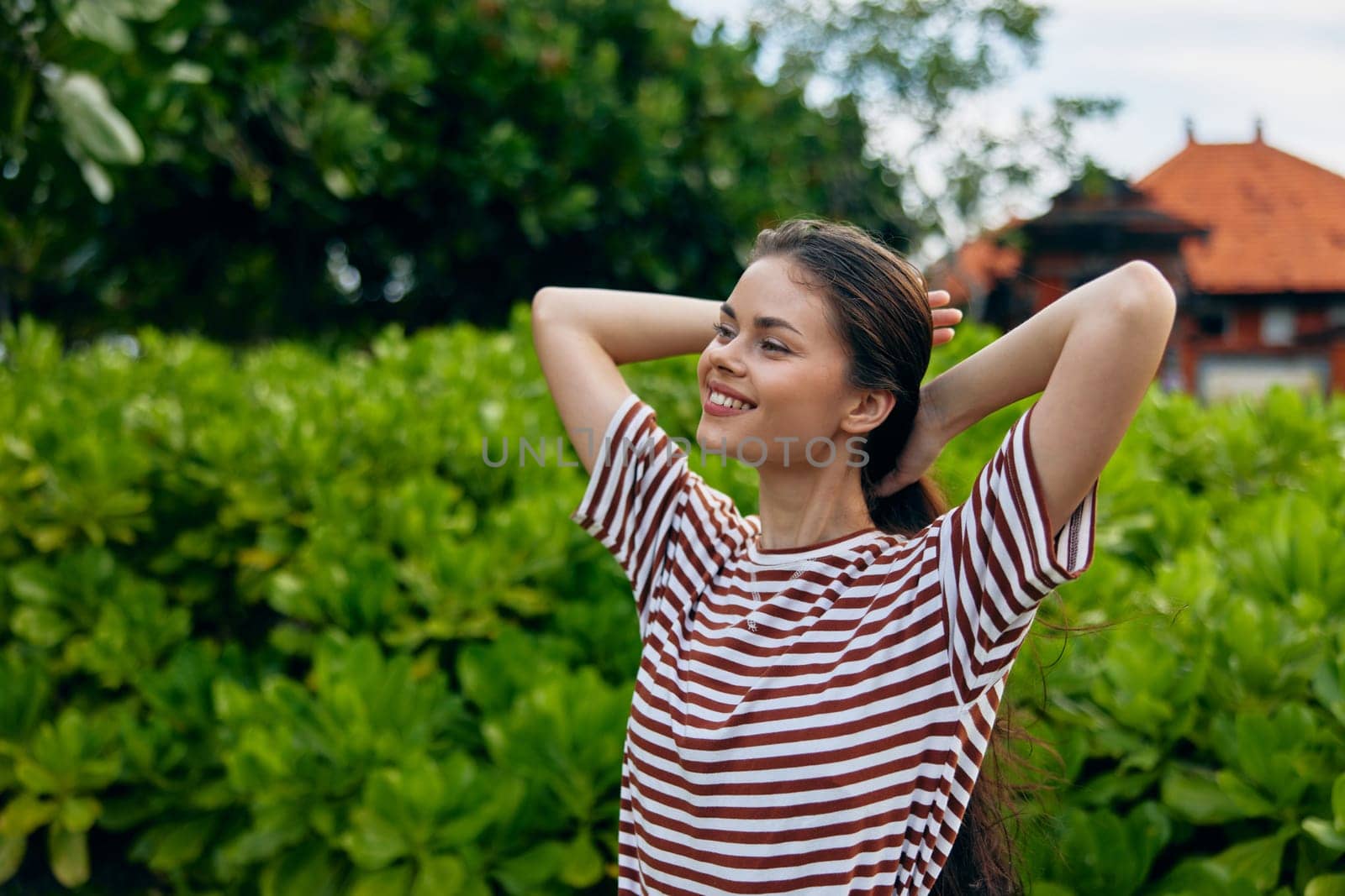 summer woman nature enjoy walk young girl freedom wellness fun t-shirt face park portrait sunset grass smiling walking outdoor lifestyle beautiful