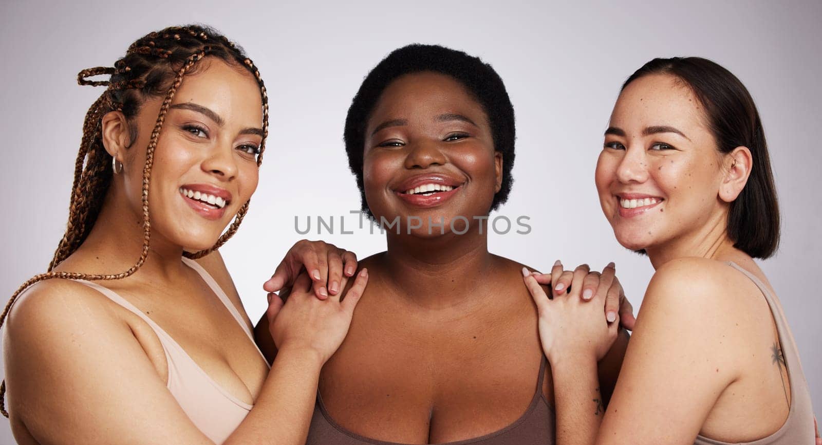 Portrait, diversity and women with skincare, cosmetics and happiness on grey studio background. Multiracial, females and ladies with empowerment, salon treatment and support with wellness and beauty by YuriArcurs