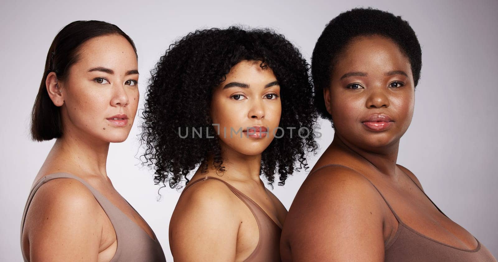 Women, diversity studio portrait and beauty for aesthetic, care or race equality with plus size solidarity. Model, asian and black woman with cosmetics, makeup and wellness with support by background.