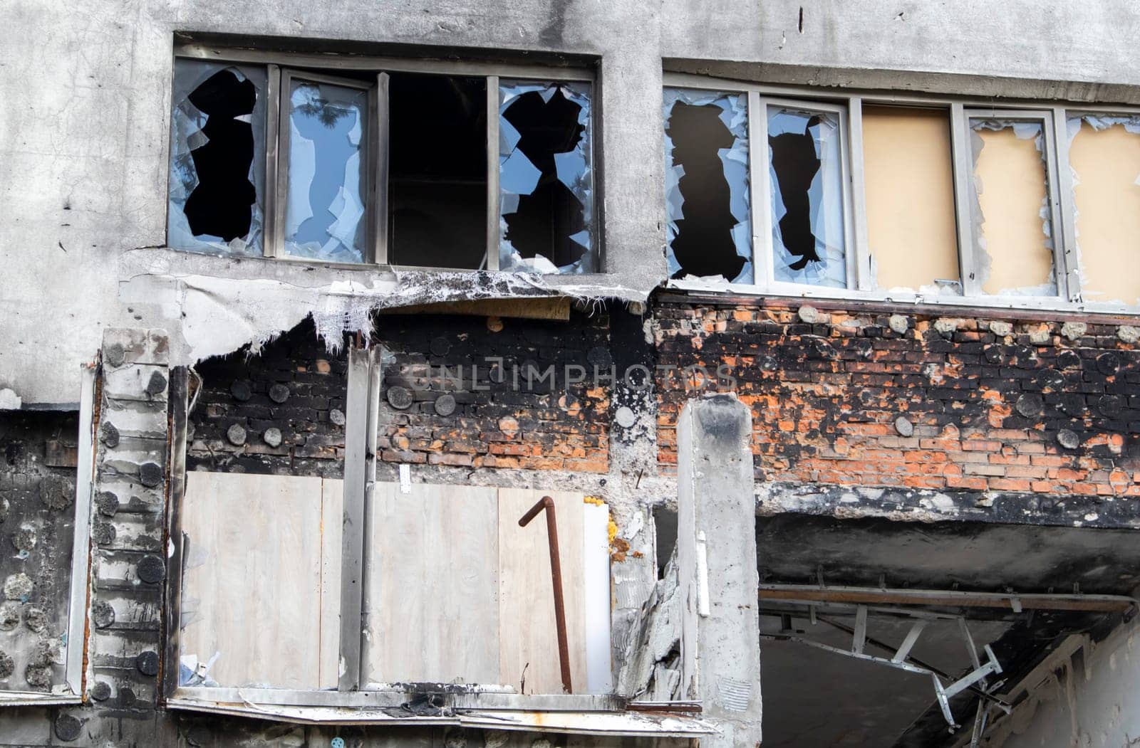 Residential buildings, windows and balconies were damaged by the blast and shrapnel from artillery shelling. The destruction of the city by military operations, the consequences of the war