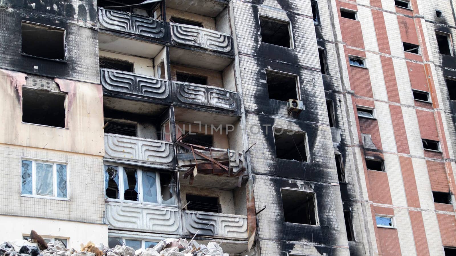 Residential buildings, windows and balconies were damaged by the blast and shrapnel from artillery shelling. The destruction of the city by military operations, the consequences of the war