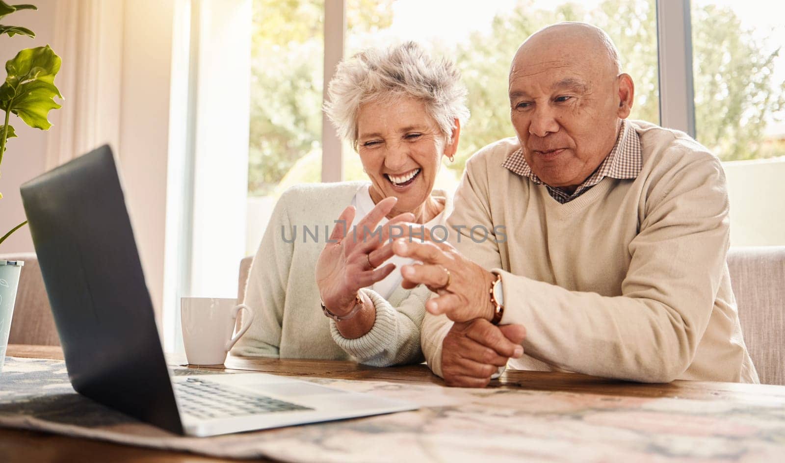 Laptop, video call and senior couple wave, talking to contact and laughing in home. Comic, technology and smile of happy retired man and woman with computer for virtual chat or online communication. by YuriArcurs