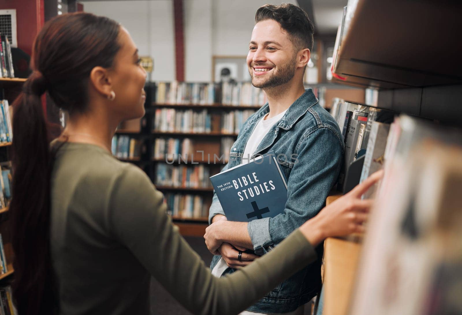 Woman, man and library for reading, talking and knowledge for studies. Students, male and female in bookstore, education or research for literature, study and for books to read, conversation or smile.