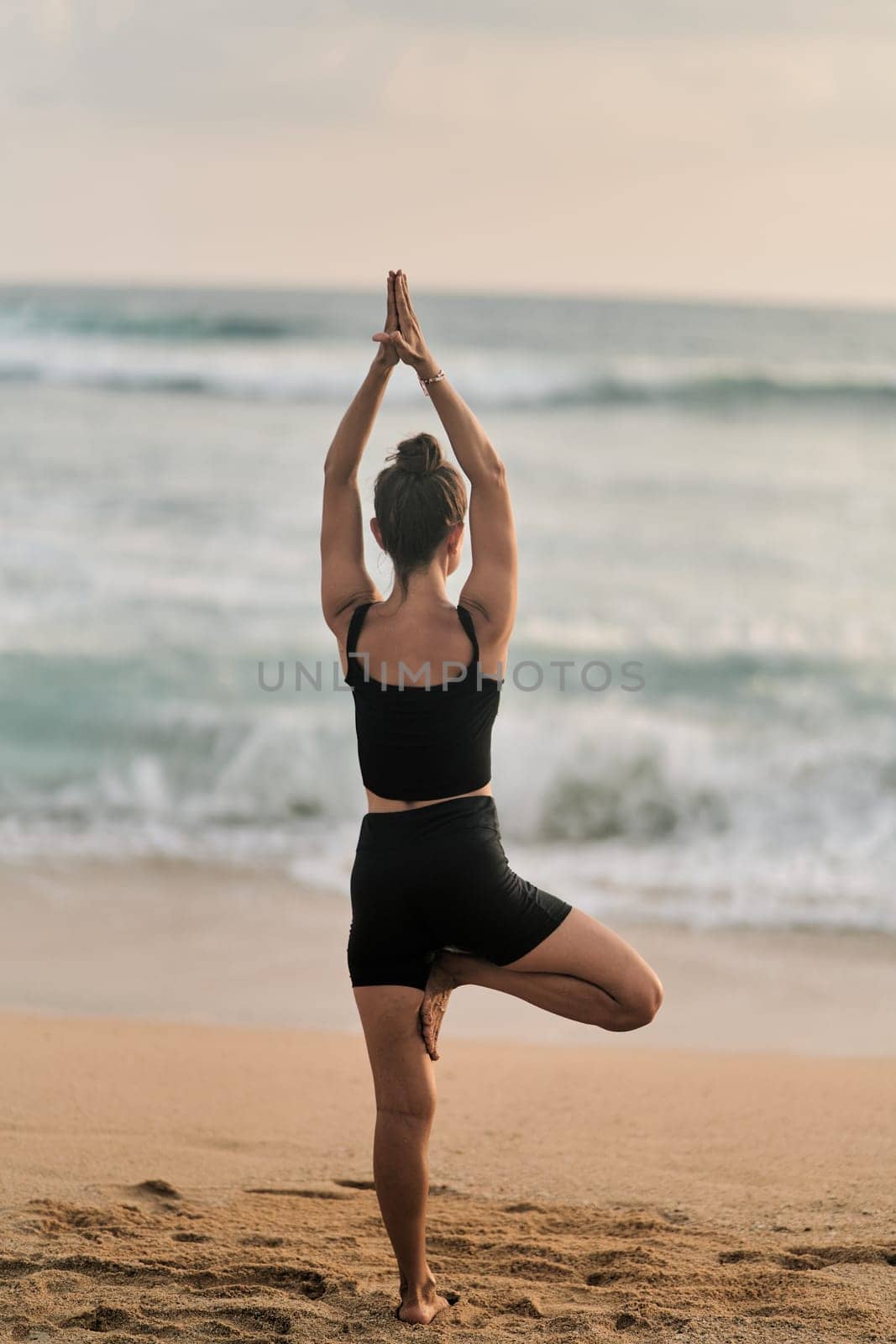 Beautiful girl doing yoga at the beach by driver-s
