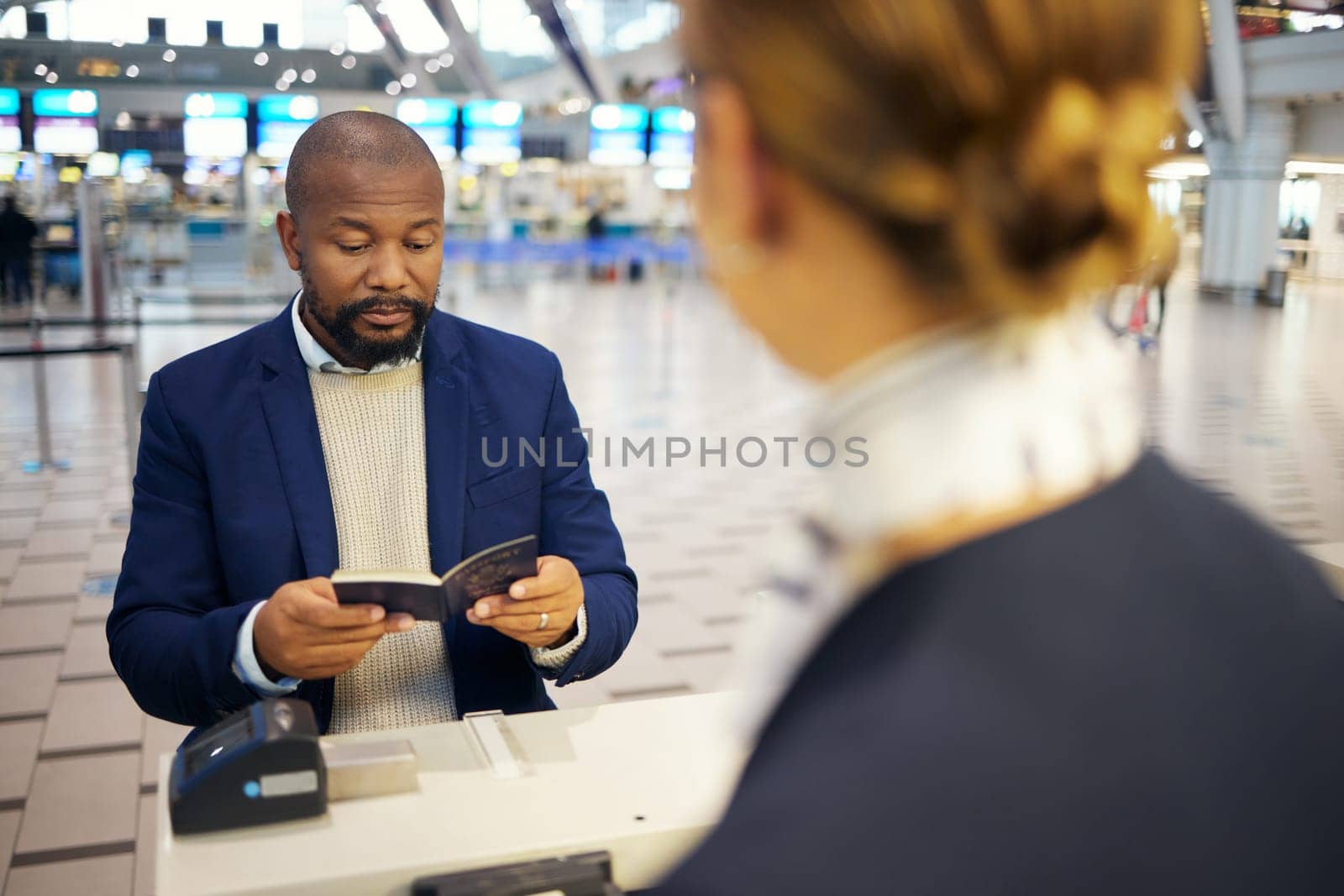 Black man, airport and passport document for woman at concierge help desk, lobby and identity for travel. African businessman, documents and immigration at inspection for international transportation.