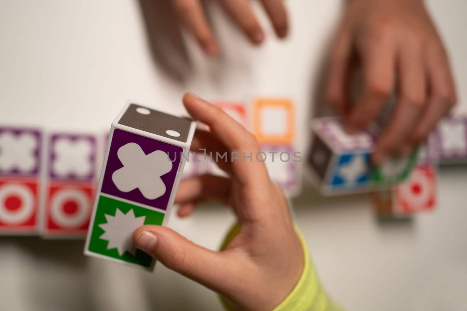 Family Table game. Strategic. Kids hands playing . Victory. Selective focus. Close-up.