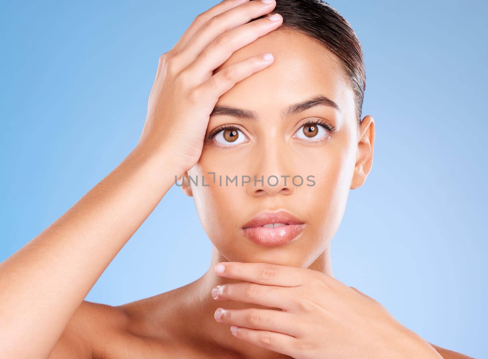 Portrait, skincare or model in studio after beauty or facial grooming routine on a blue background with mockup space. Luxury, healthy girl or beautiful woman touching face for self love or self care.