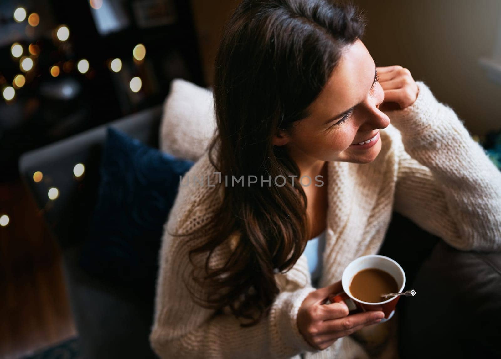 The weekend is a time to slow it down. an attractive young woman relaxing on the sofa with a cup of coffee at home