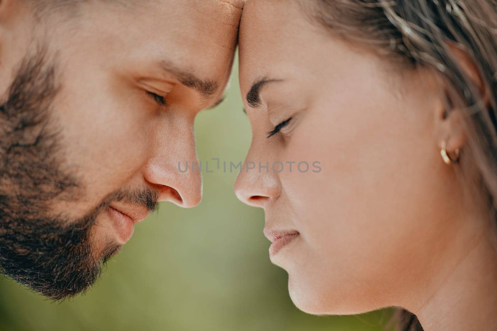 Couple, forehead and love for care, relationship or support in romance or quality bonding time together in the outdoors. Closeup of man and woman relaxing heads embracing healthy partnership outside.