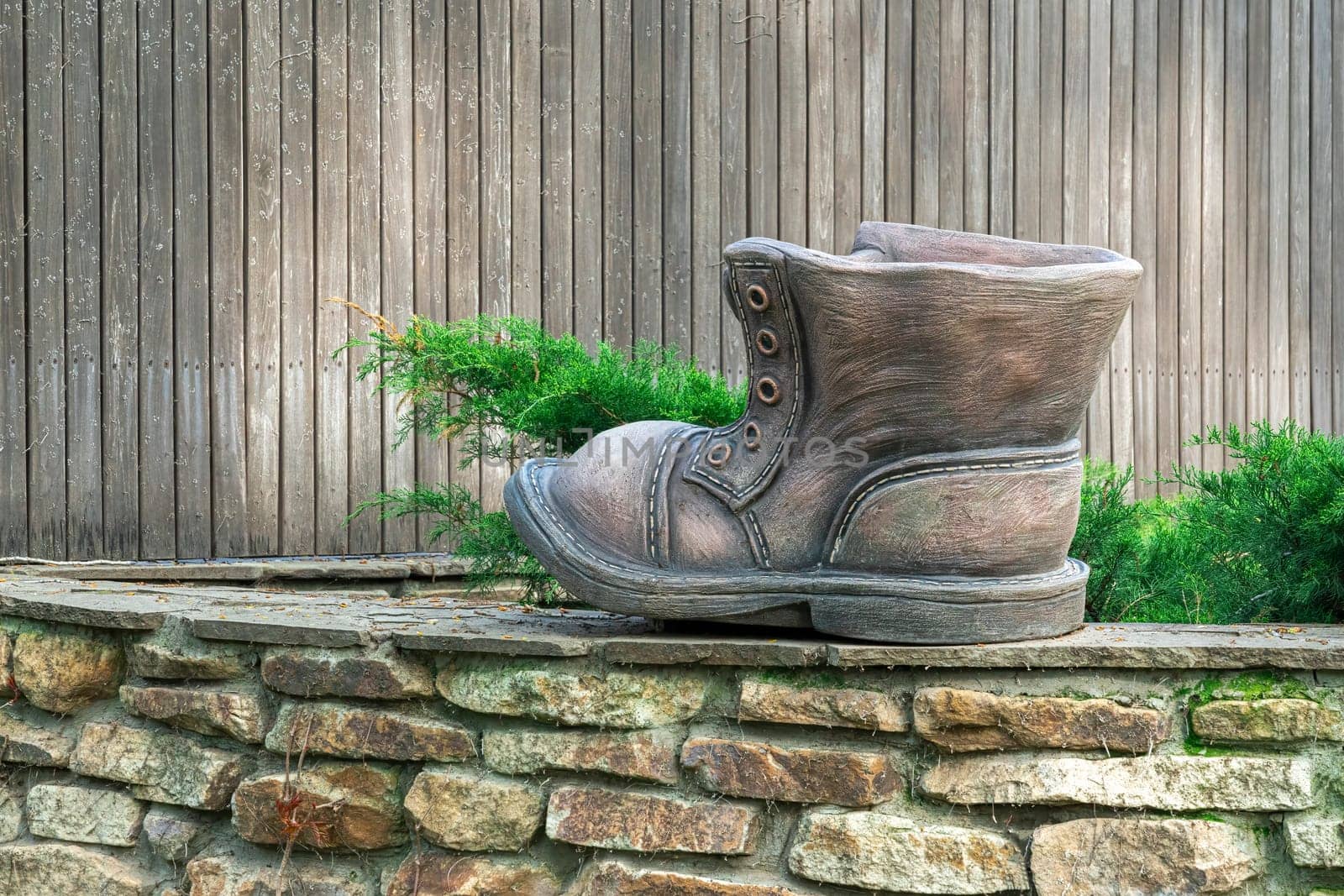 sculpture of a wooden shoe with laces close-up by roman112007