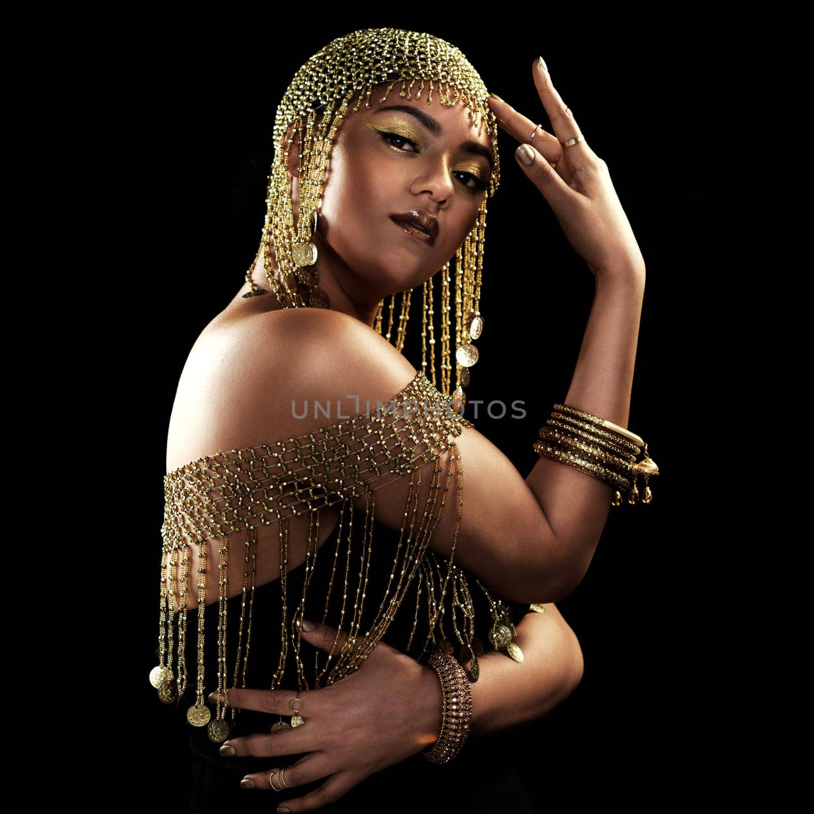 African woman, portrait and gold fashion with beauty and cosmetics in a studio. Isolated, black background and young female face with crown, Egypt jewelry and culture empowerment with queen pride.