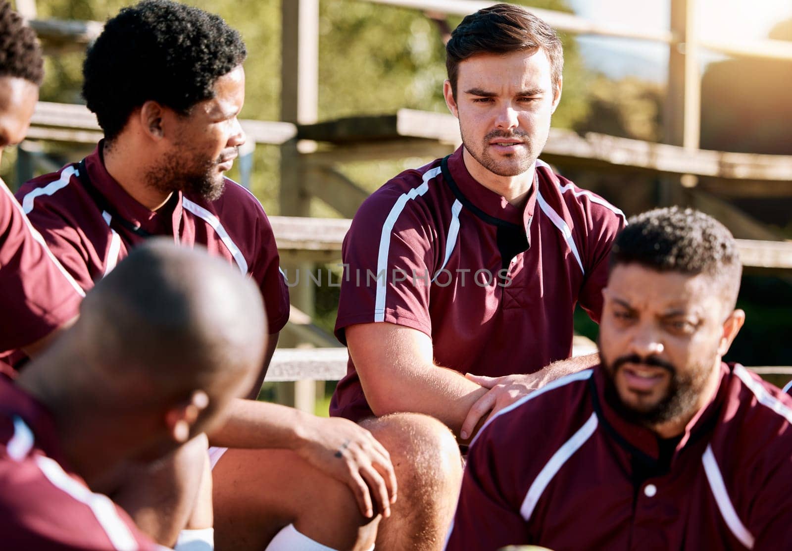 Break, rugby and team of sports men talking, relax and share ideas for training at a field. Fitness, friends and man group discuss game strategy before match, workout and planning practice in huddle.