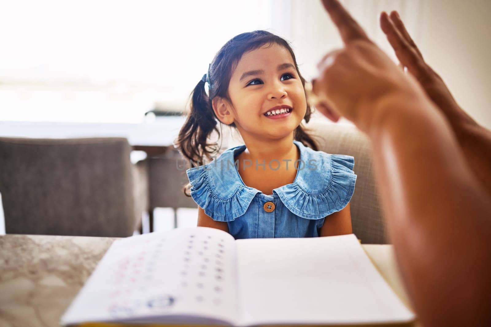 Education, homeschool and a kindergarten girl with smile, notebook and help from mother in math class. Home school, happy child and learning to count on fingers and hands, woman teaching kid maths