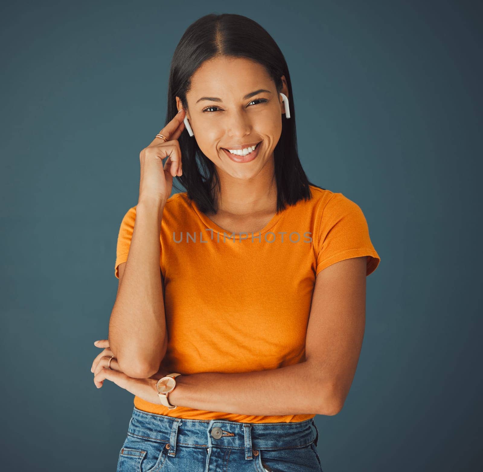 Woman, portrait and listening to music online while happy on a studio background. Smile on face of a young gen z person with earphones for podcast, radio or audio sound to relax while streaming.