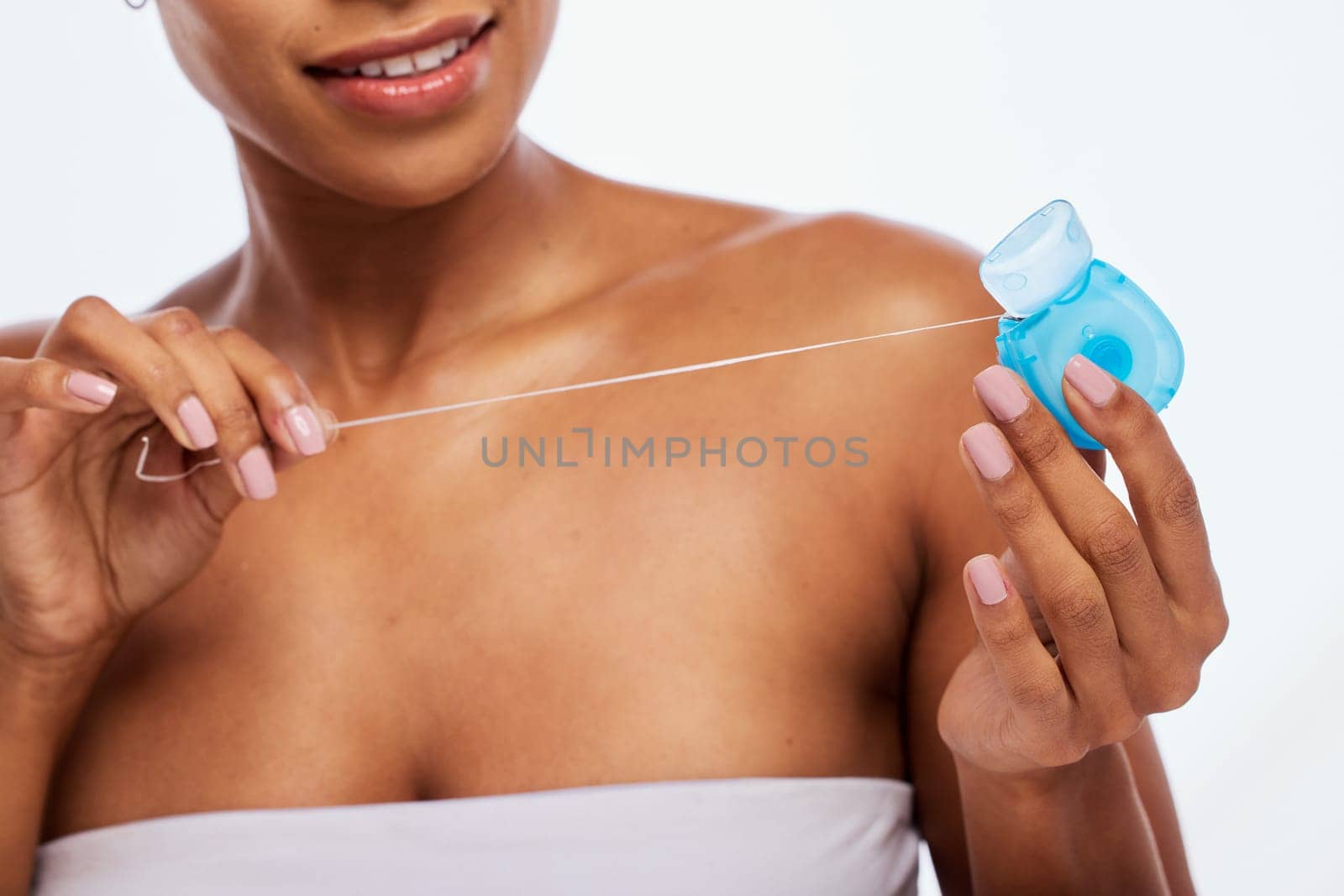 Dental, floss in hands and black woman, flossing for teeth whitening, health and hygiene isolated on white background. Oral care product, skincare and mouth cleaning for fresh breath in studio by YuriArcurs