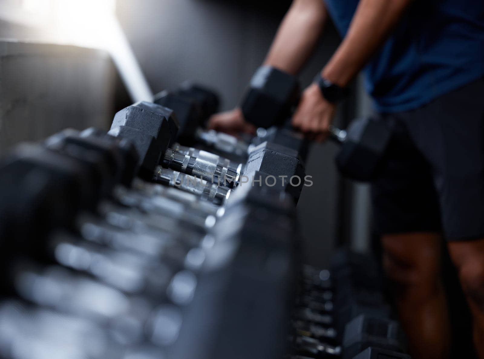Man, hands or dumbbells in gym workout, training or exercise for strong muscle growth, healthcare wellness or bodybuilding. Zoom, texture or heavy metal weights for fitness coach or personal trainer.