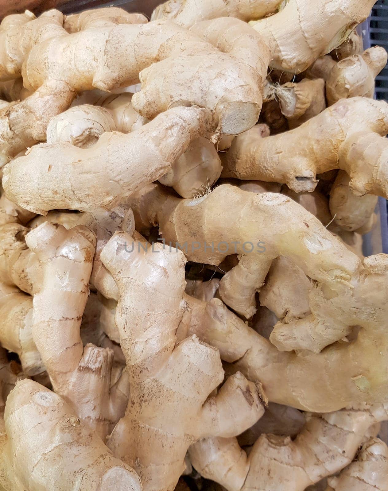 Fresh organic ginger on the fresh food market, vertical background by claire_lucia