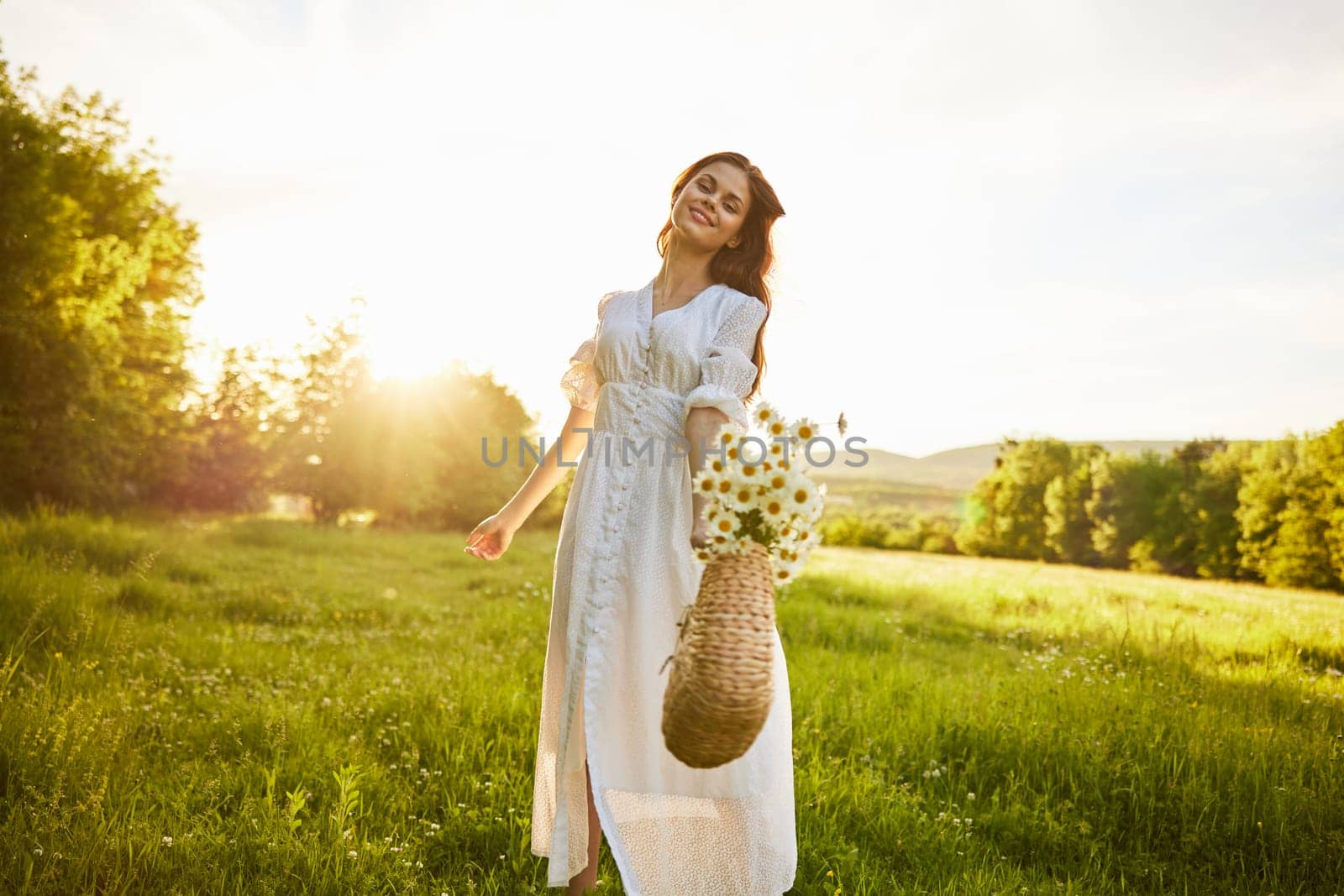 a woman in a light dress holds out a basket of daisies into the camera. High quality photo