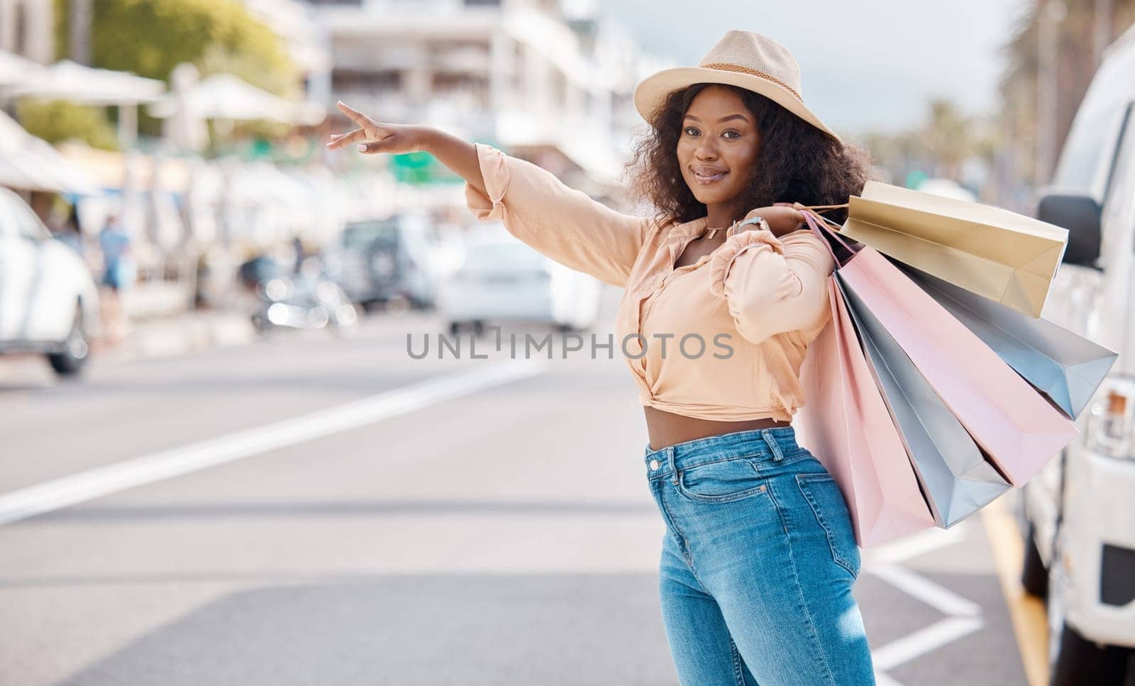 Retail, shopping and taxi with black woman in city for travel, luxury and fashion in urban street. Happy, sales and gift with customer and discount bag in road to call cab transportation service.